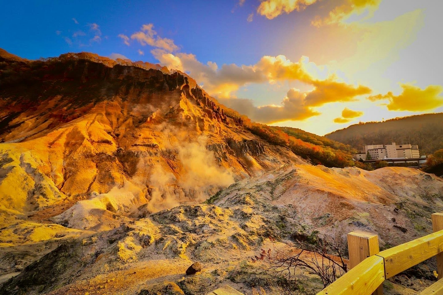 Scenic view of a mountain at sunset with steam rising from the ground