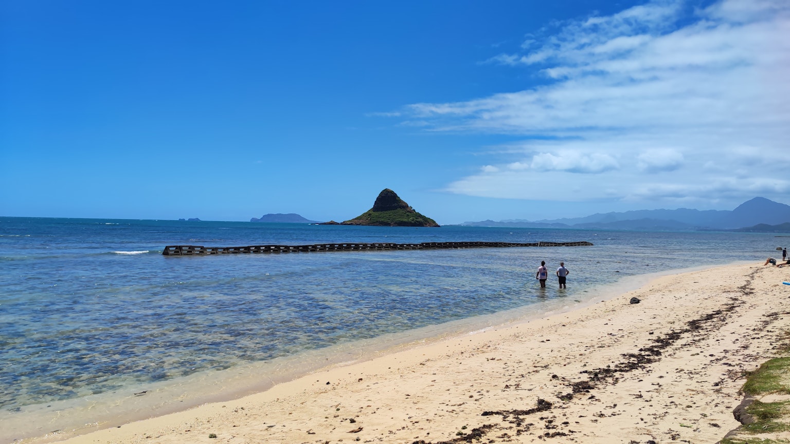 Plage pittoresque avec une eau claire et une petite île au loin