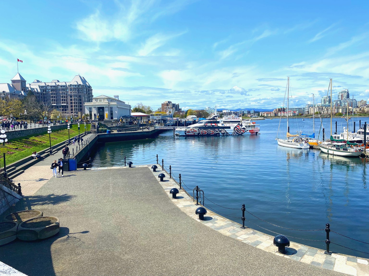 A serene harbor scene with boats under a clear blue sky