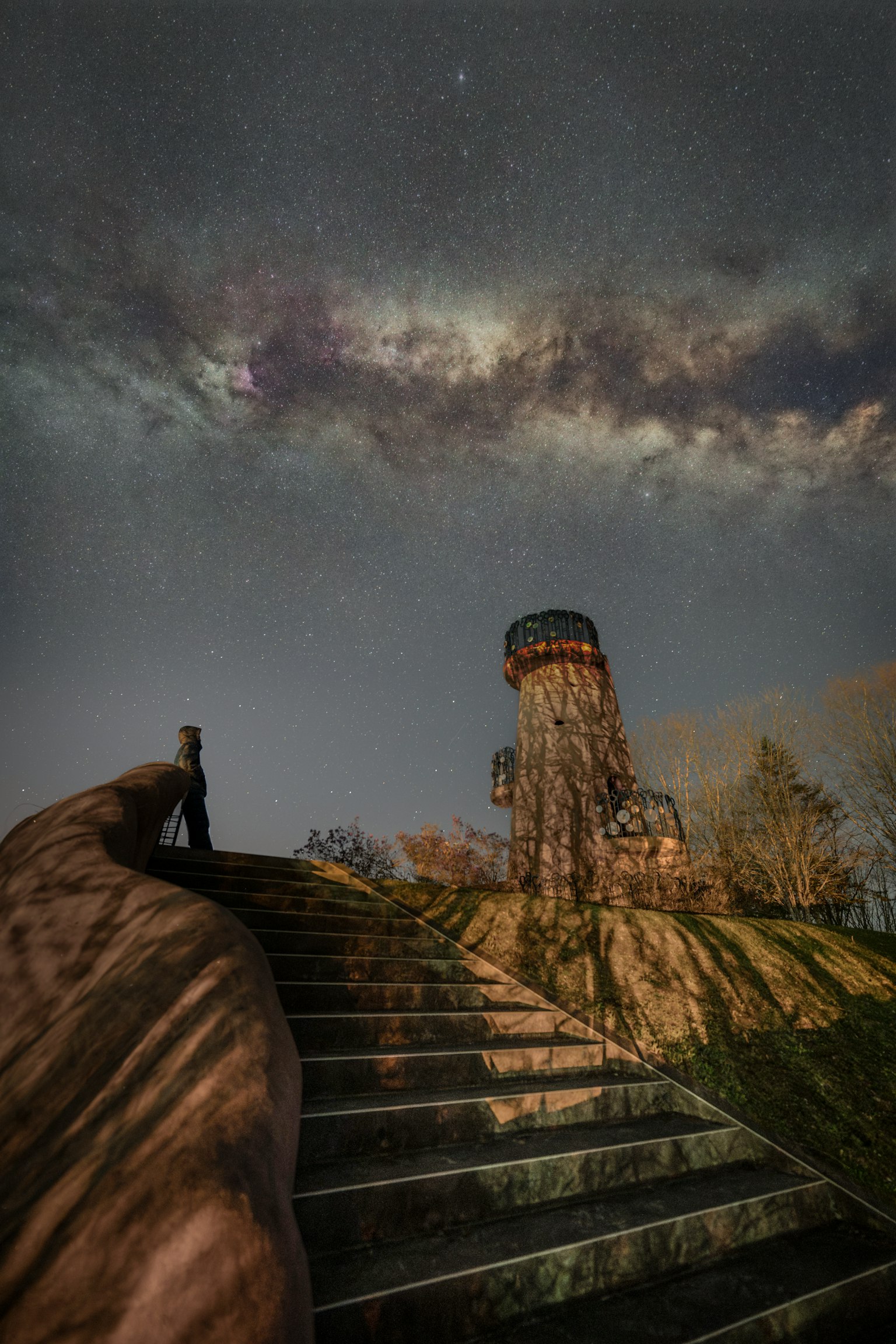 Staircase leading up to a tower under a starry night sky