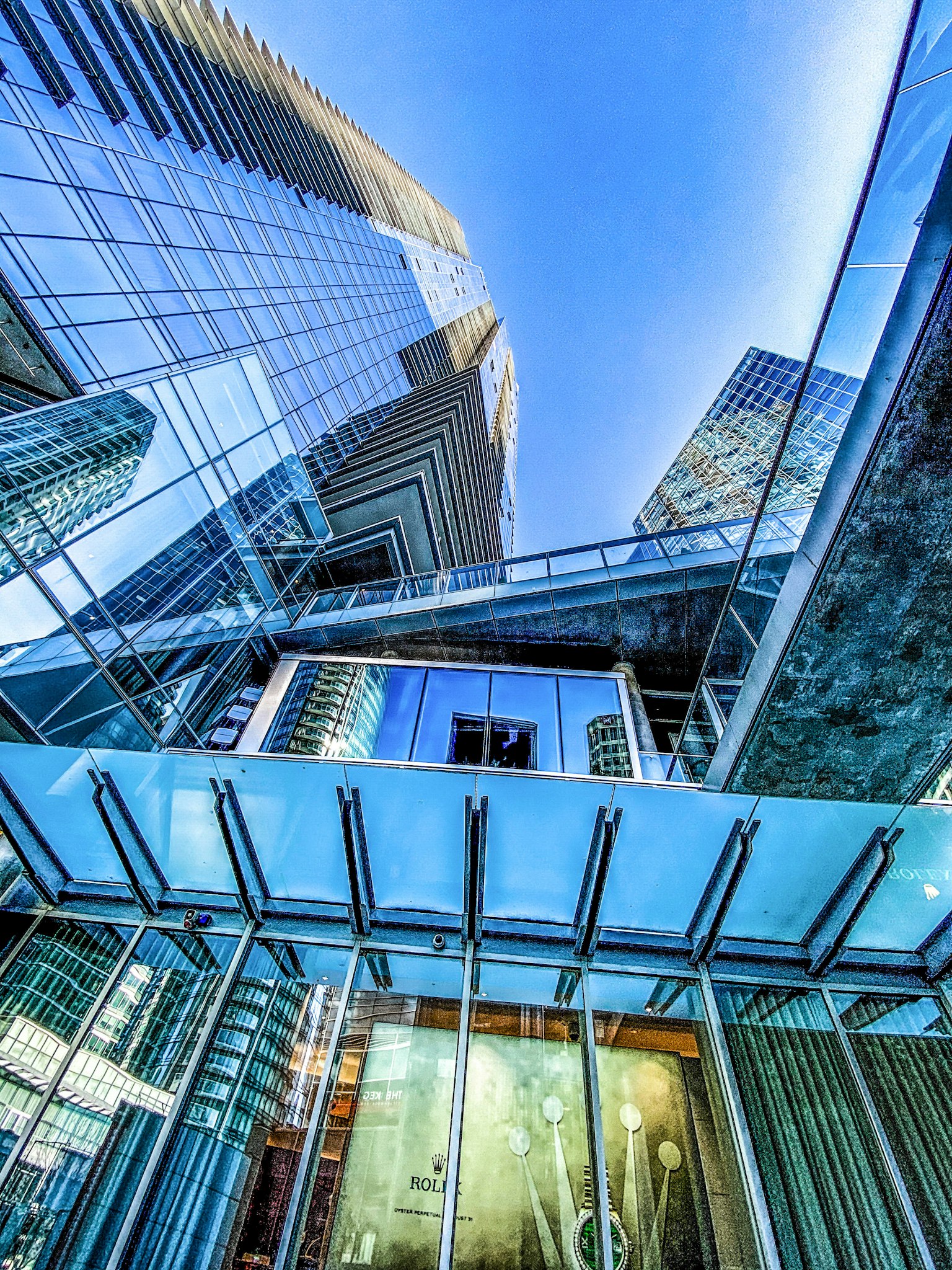 Modern skyscrapers and glass structures reflecting the blue sky