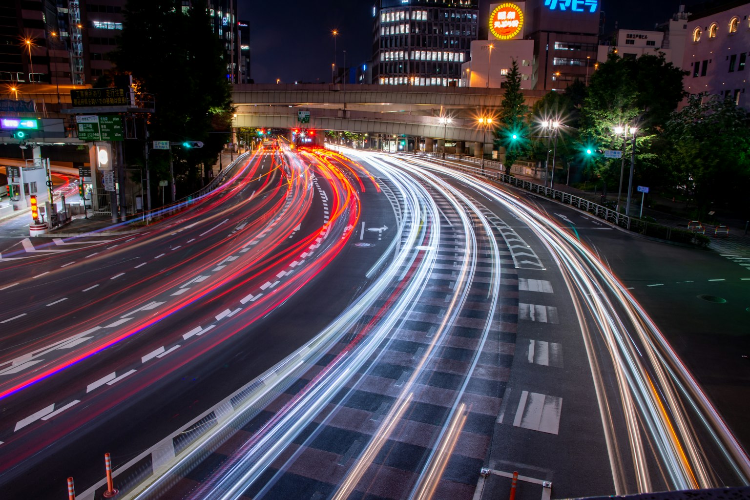 Beautiful light trails of vehicles flowing at a city intersection at night