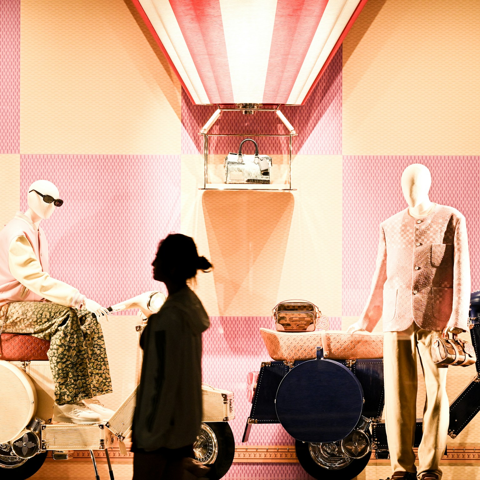 Fashion window display featuring mannequins stylishly dressed against a colorful backdrop