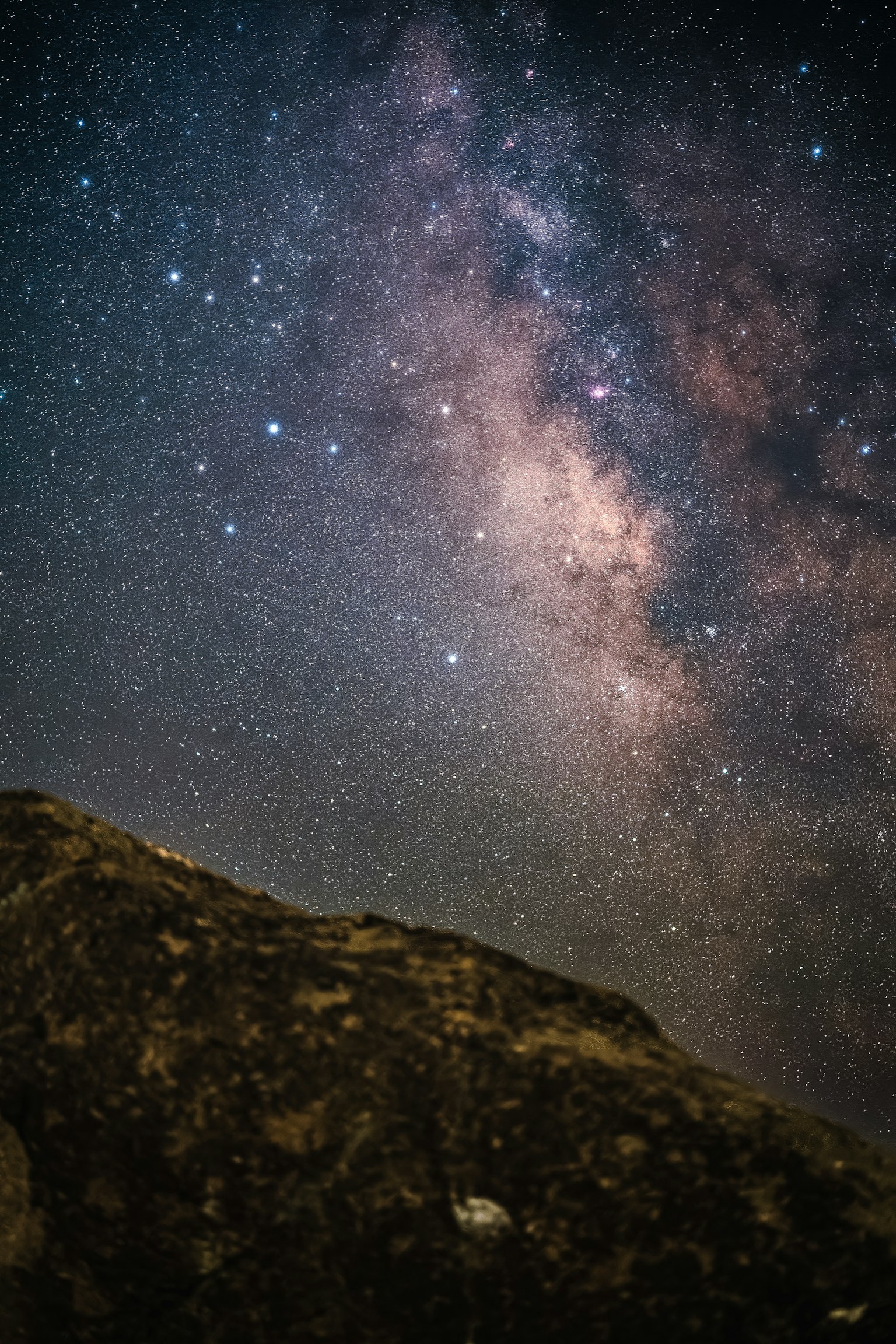Night sky view with the Milky Way and a rock formation