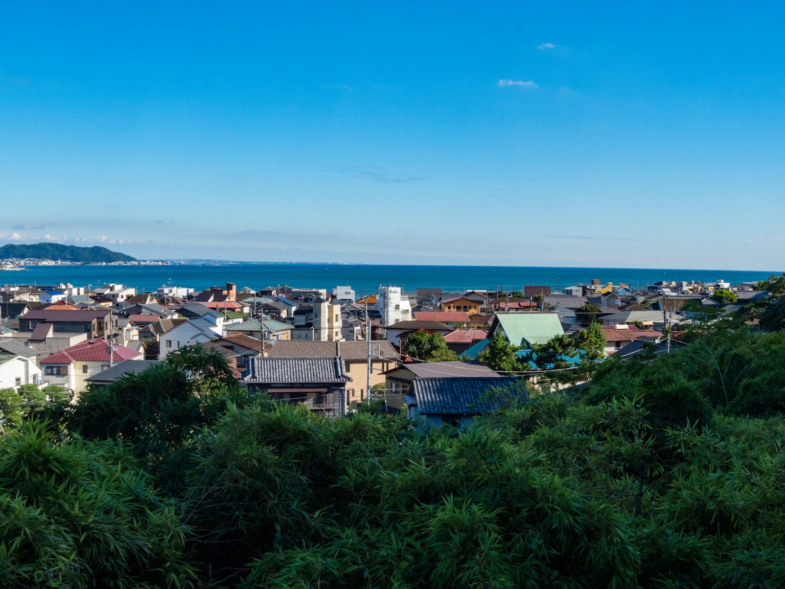 A scenic view of a coastal town under a blue sky