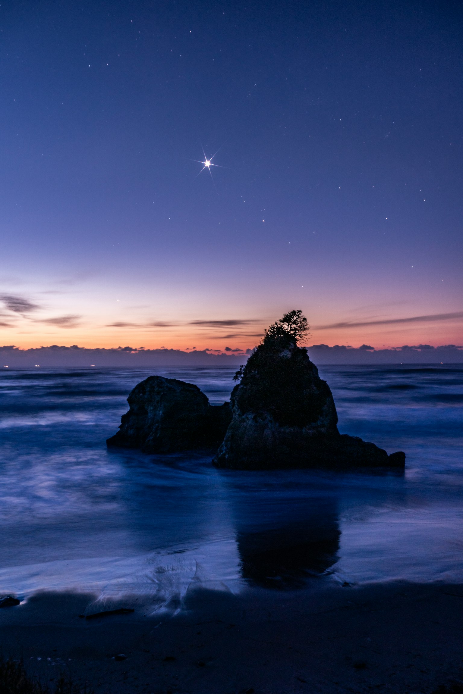 Rock formation at twilight with a bright star