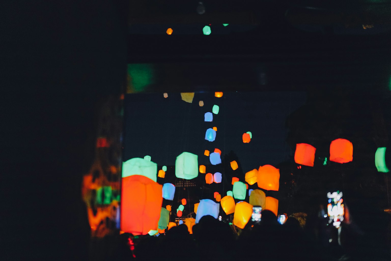 Colorful lanterns illuminated against a dark background creating a vibrant display