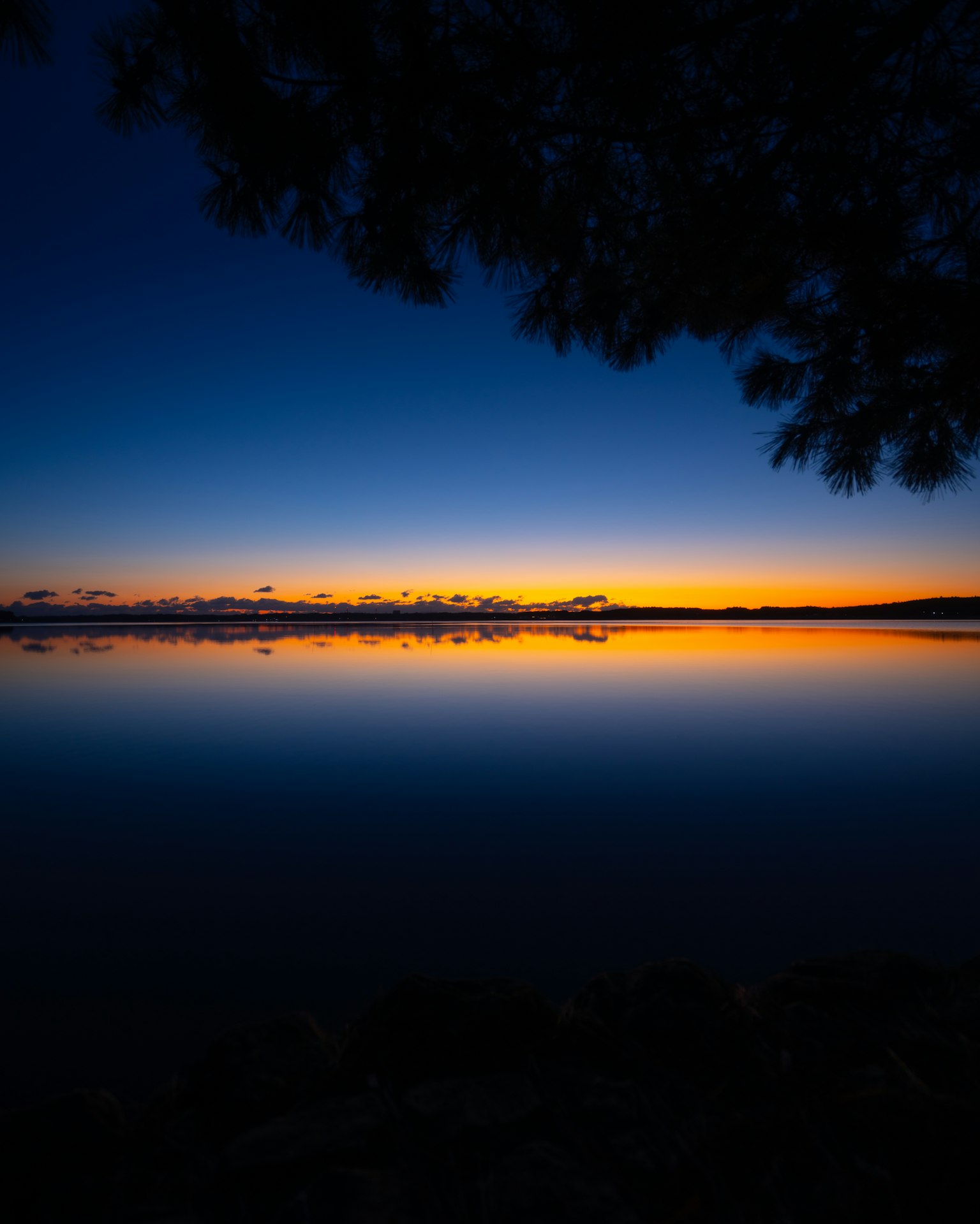 Beautiful sunset over a calm lake with reflections