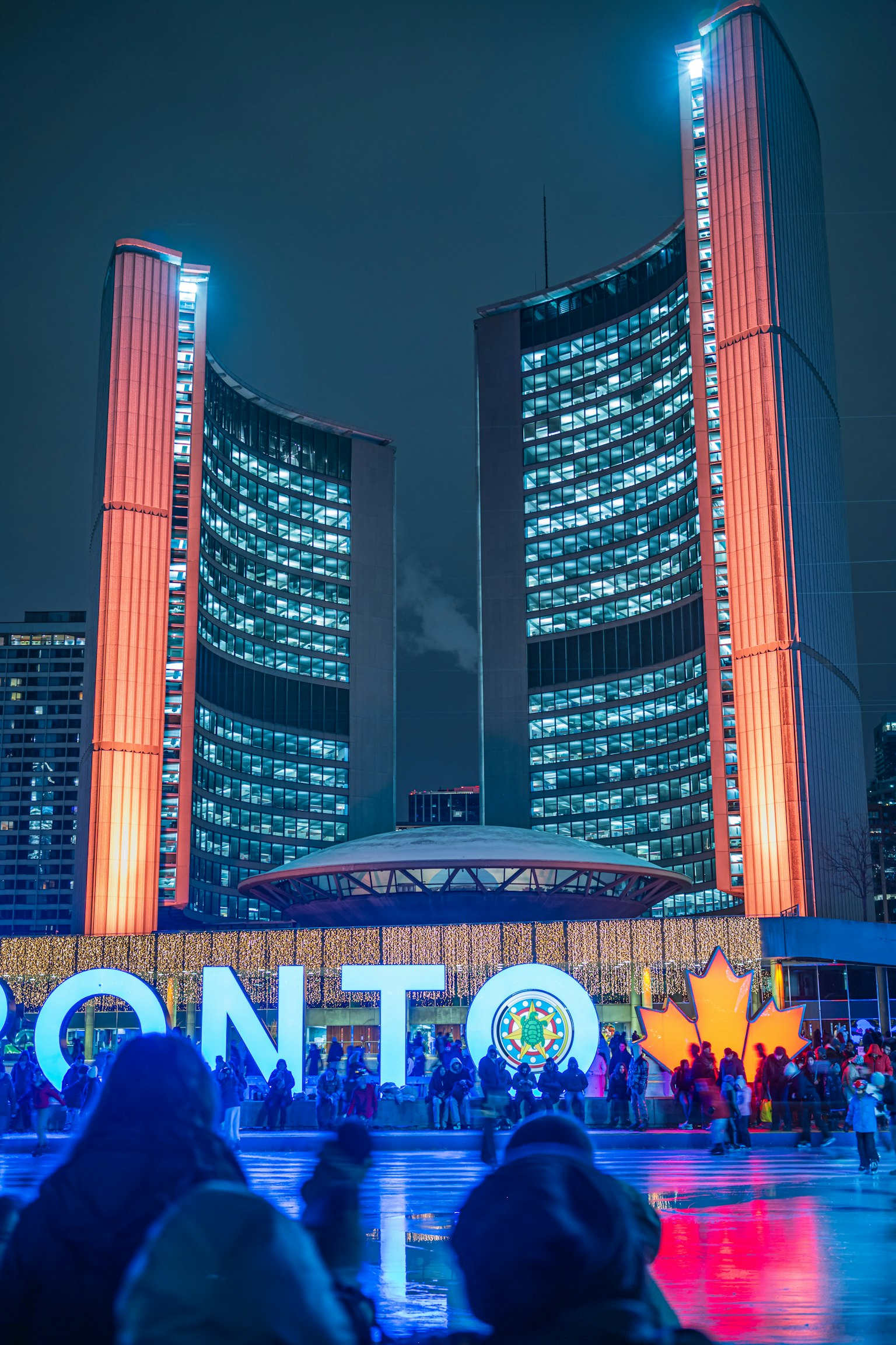 Toronto cityscape at night with illuminated city hall