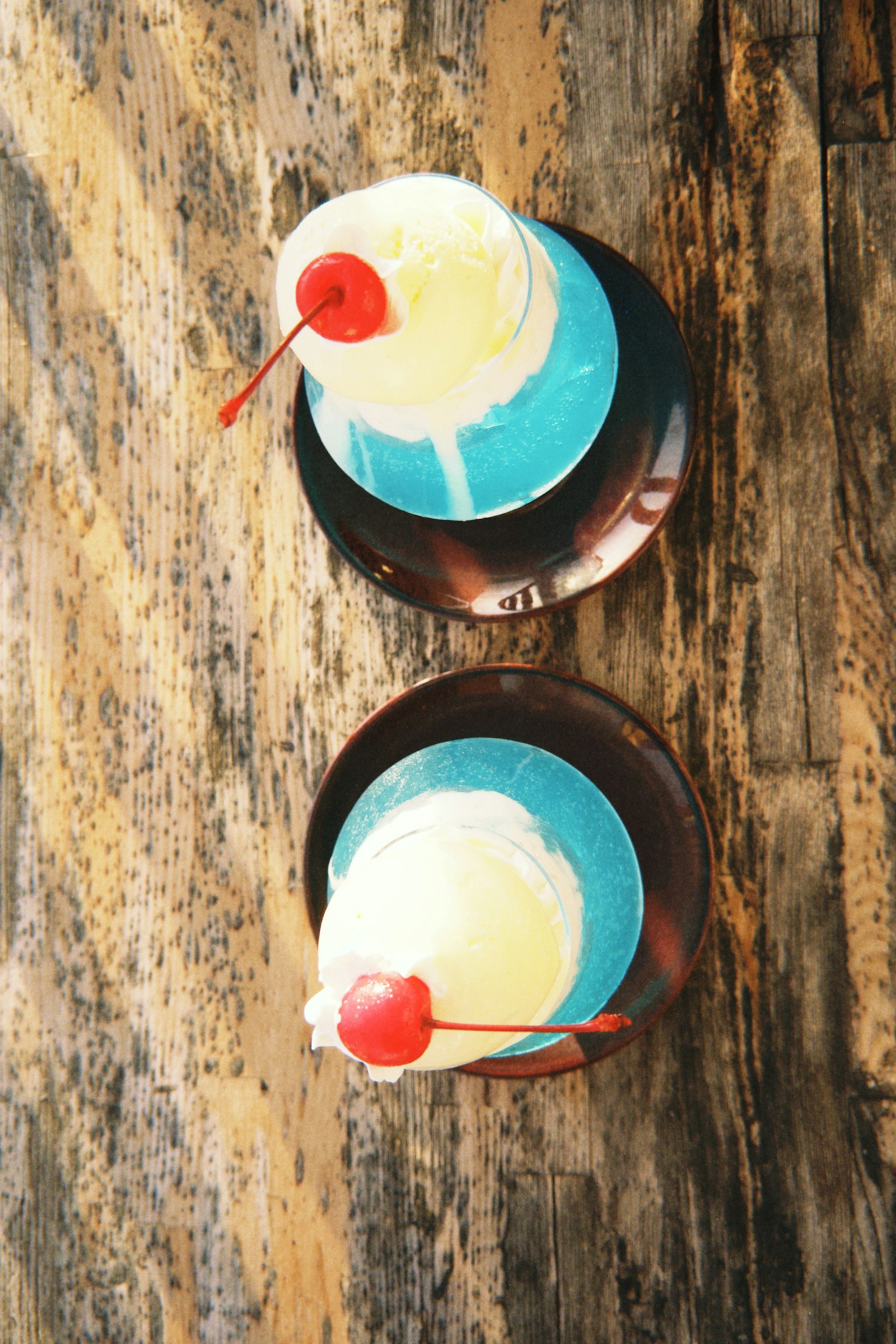 Dessert con gelato blu e bianco guarnito con ciliegie