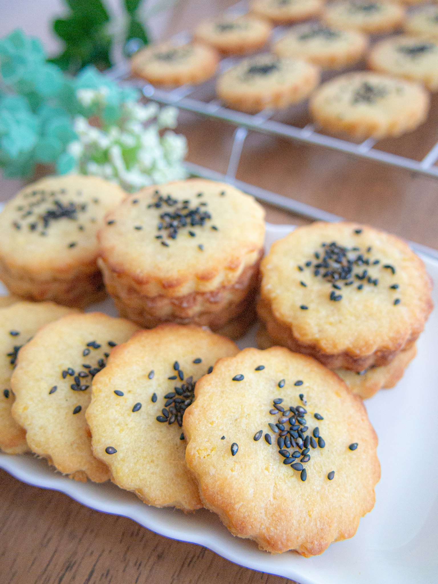 A platter of baked goods topped with black sesame seeds
