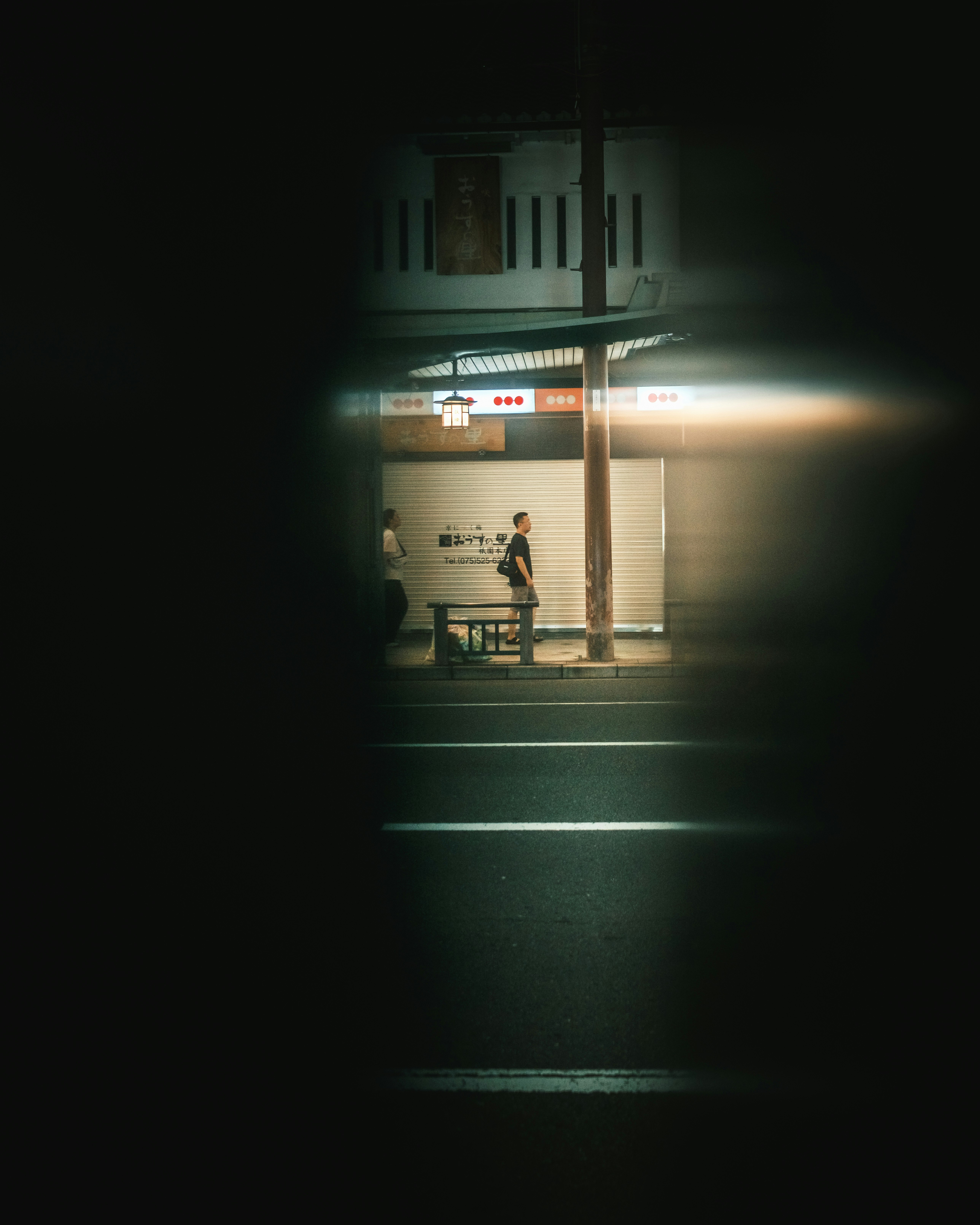 nighttime station entrance with streak-like light trails