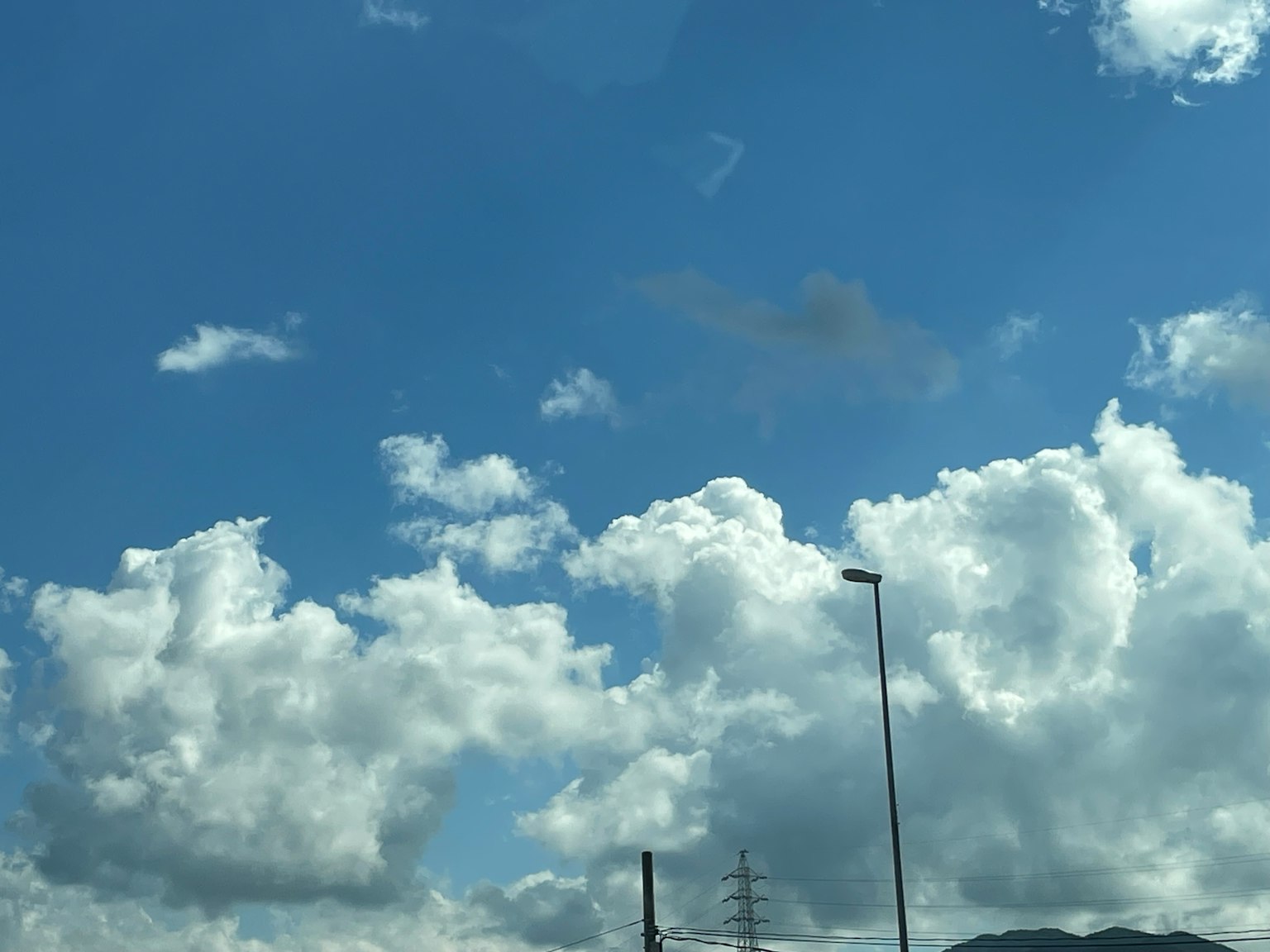 A scenic view of blue sky with fluffy white clouds