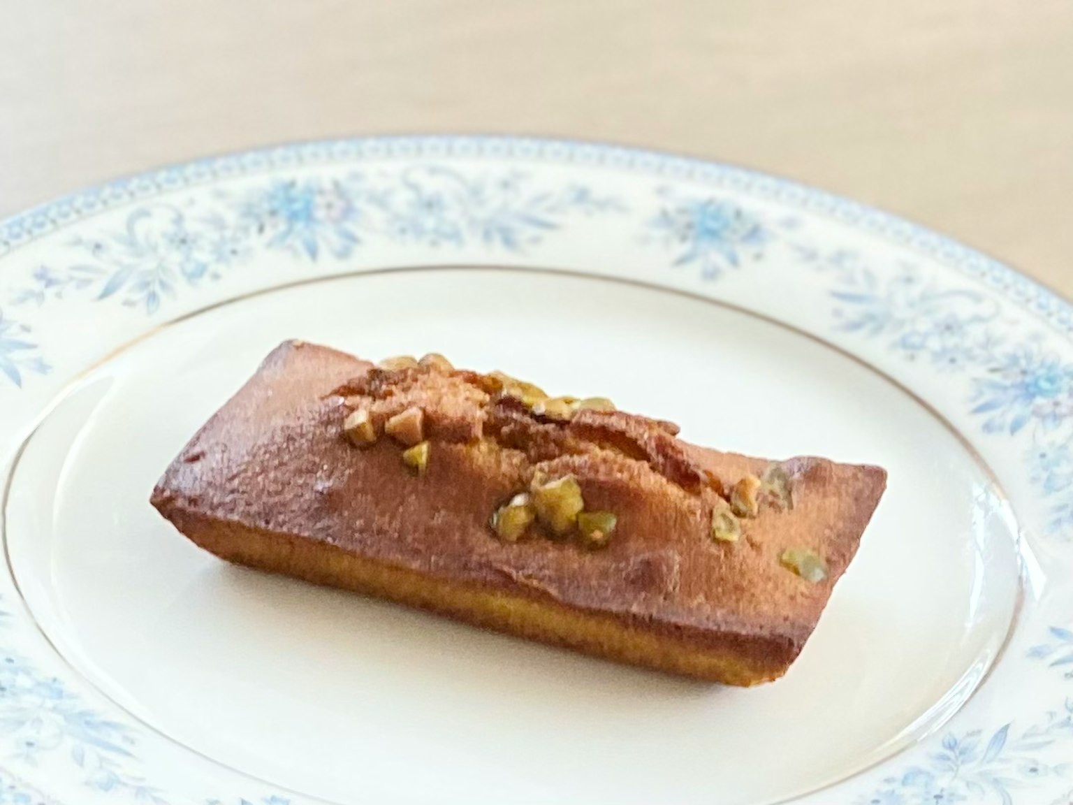 Almond-flavored financier pastry on a decorative plate