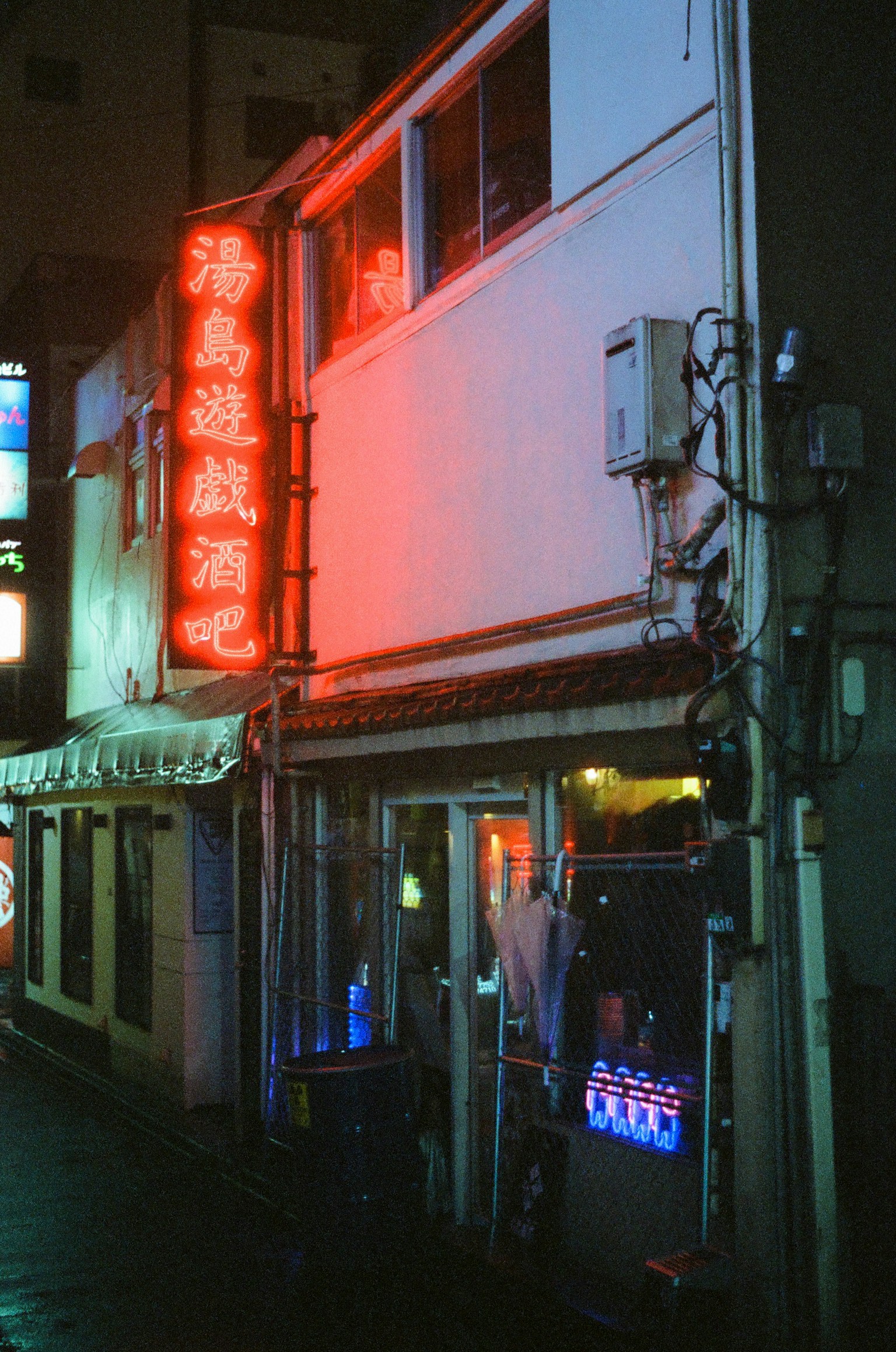 Exterior of a restaurant featuring a prominent red neon sign
