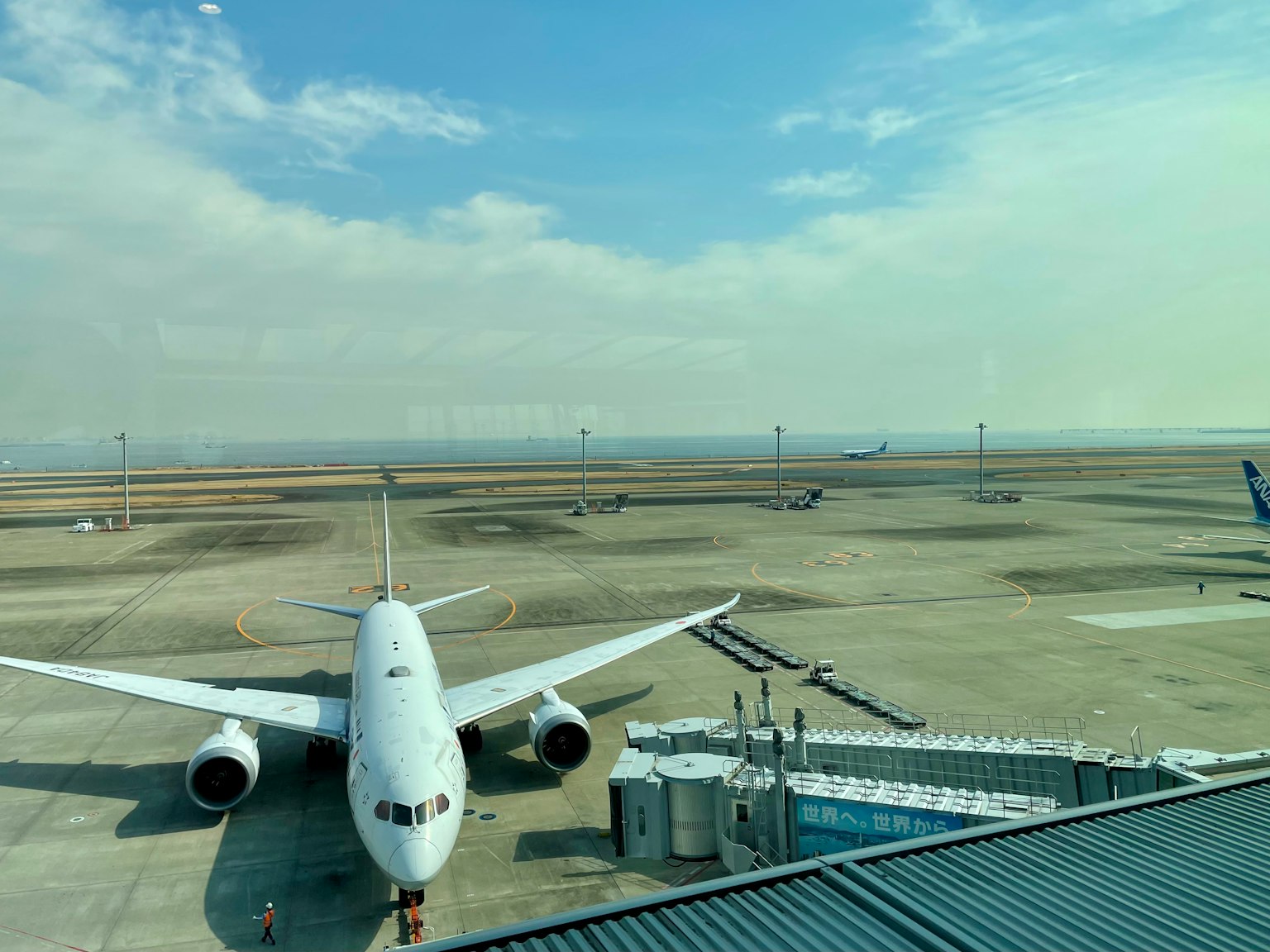 Airplane parked on the runway with a vast sky in the background