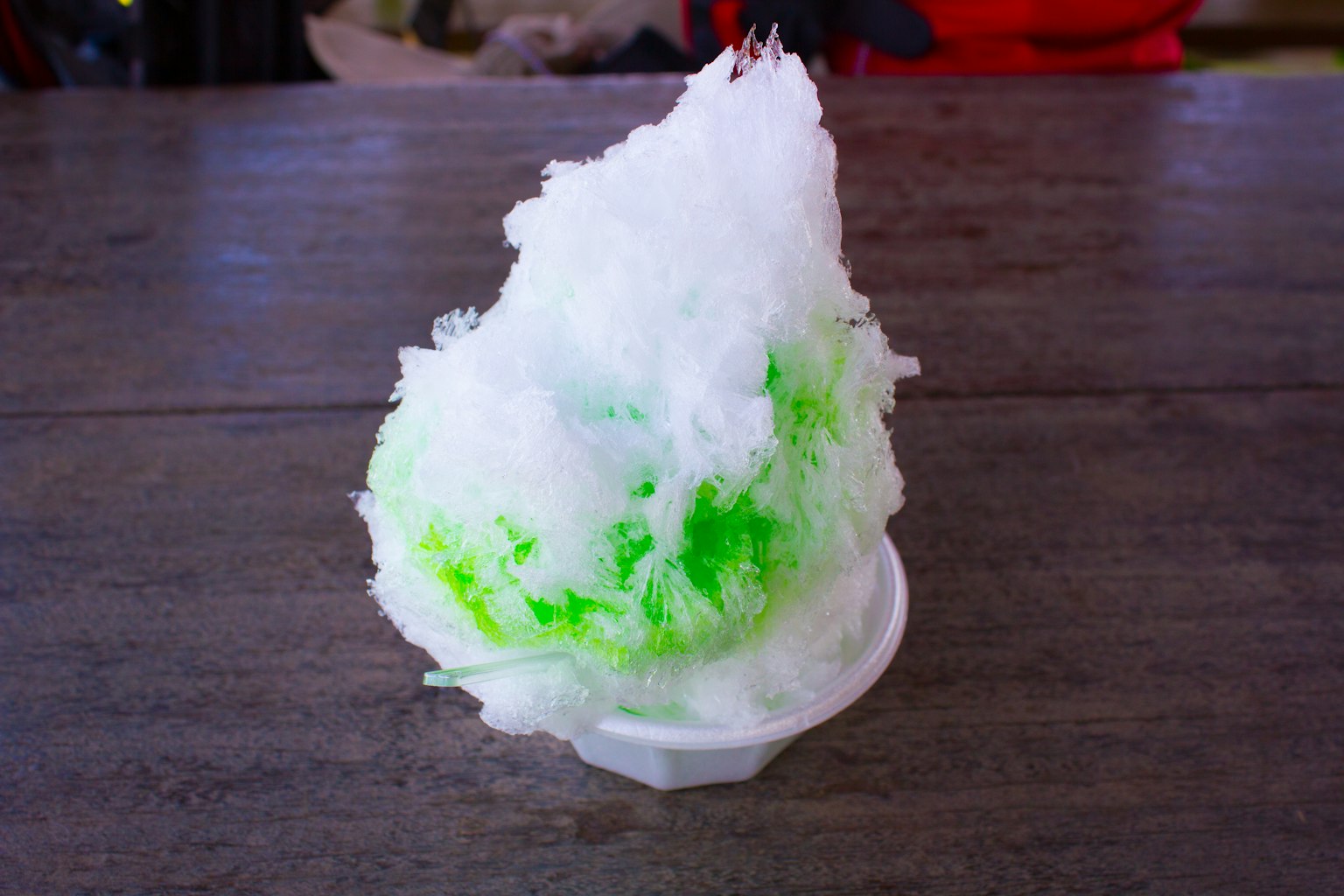 Shaved ice topped with green syrup