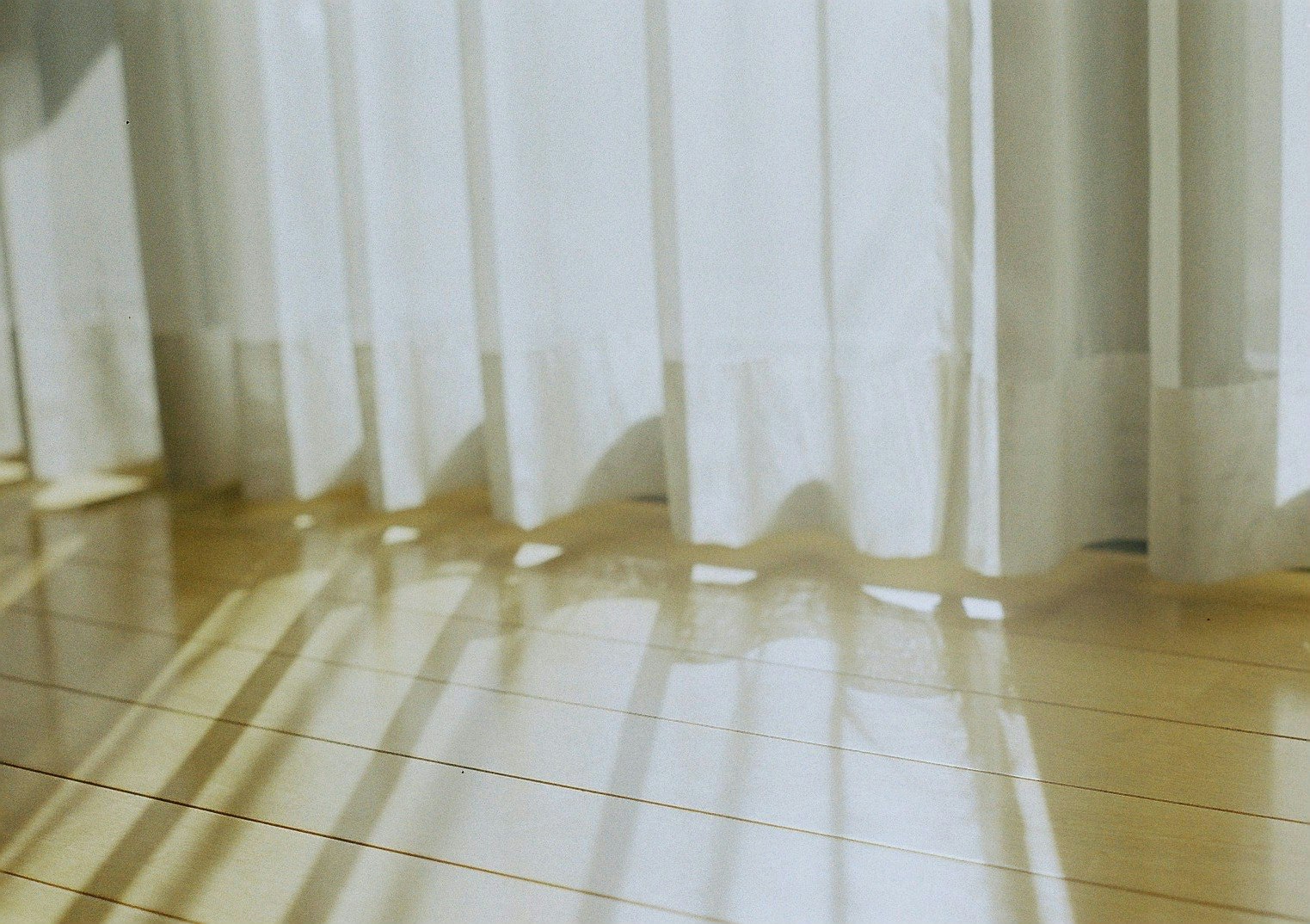 indoor floor with soft light streaming through curtains