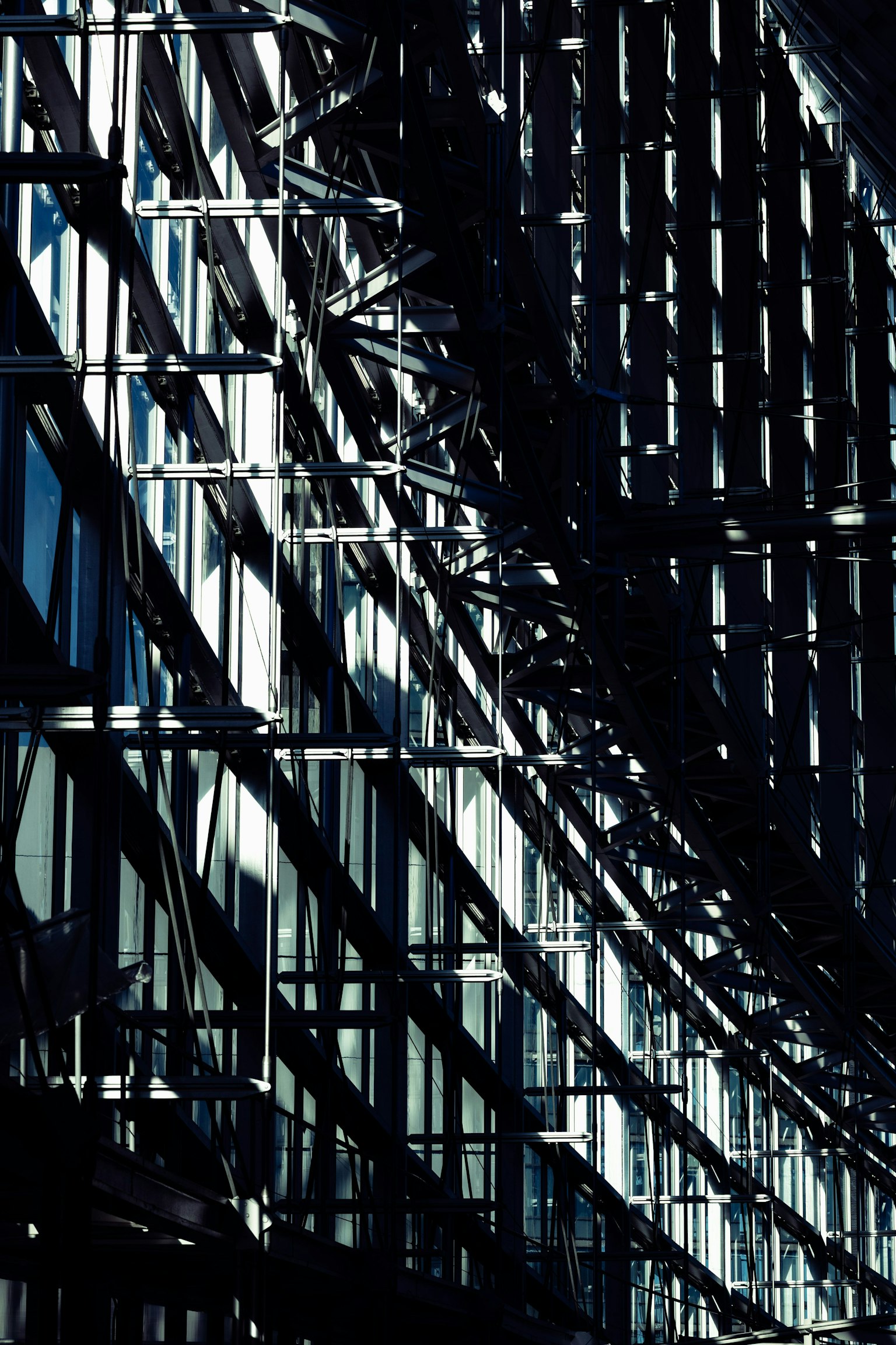 Curved glass building facade with reflective light