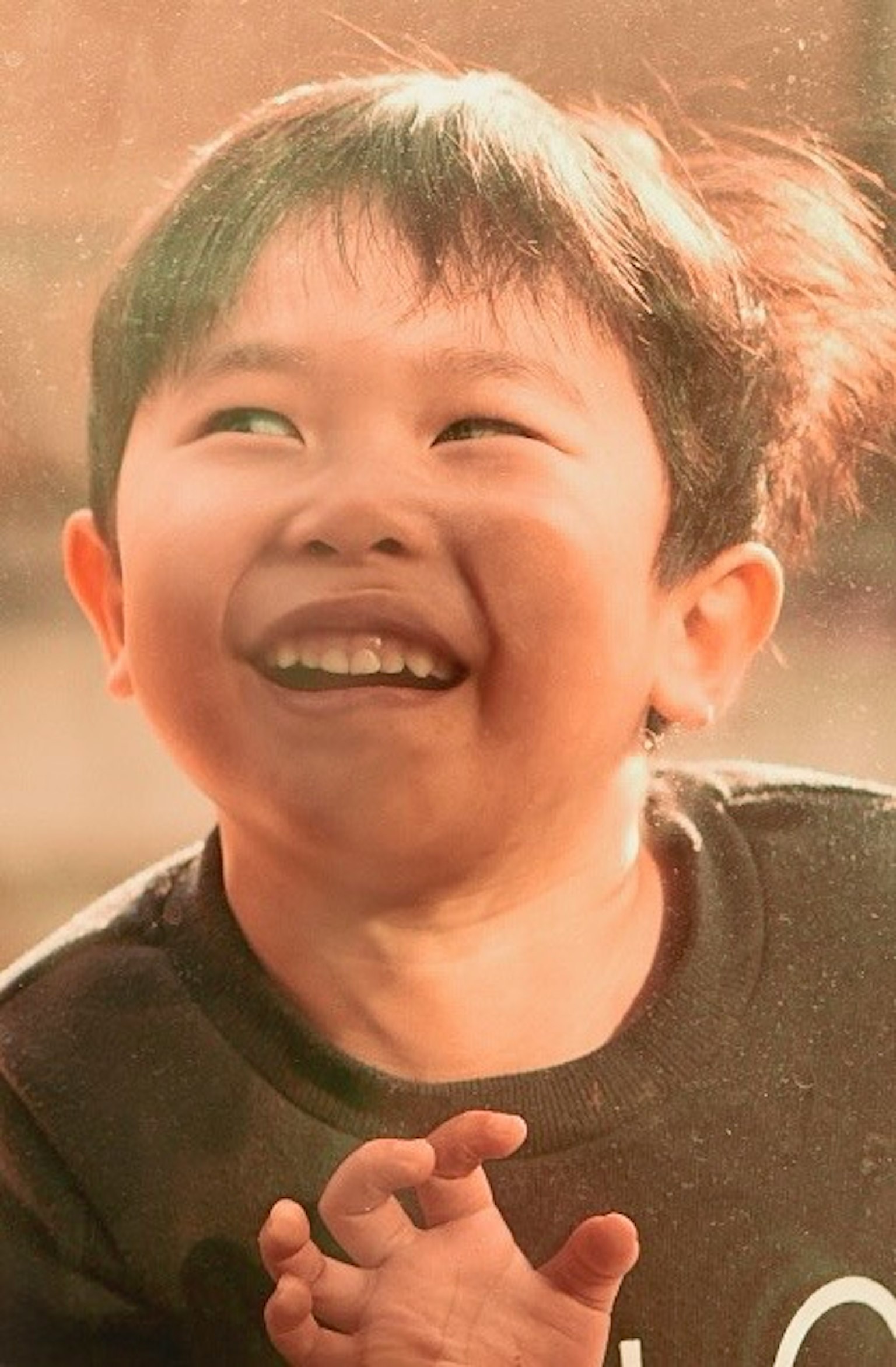 Smiling boy joyfully playing outdoors