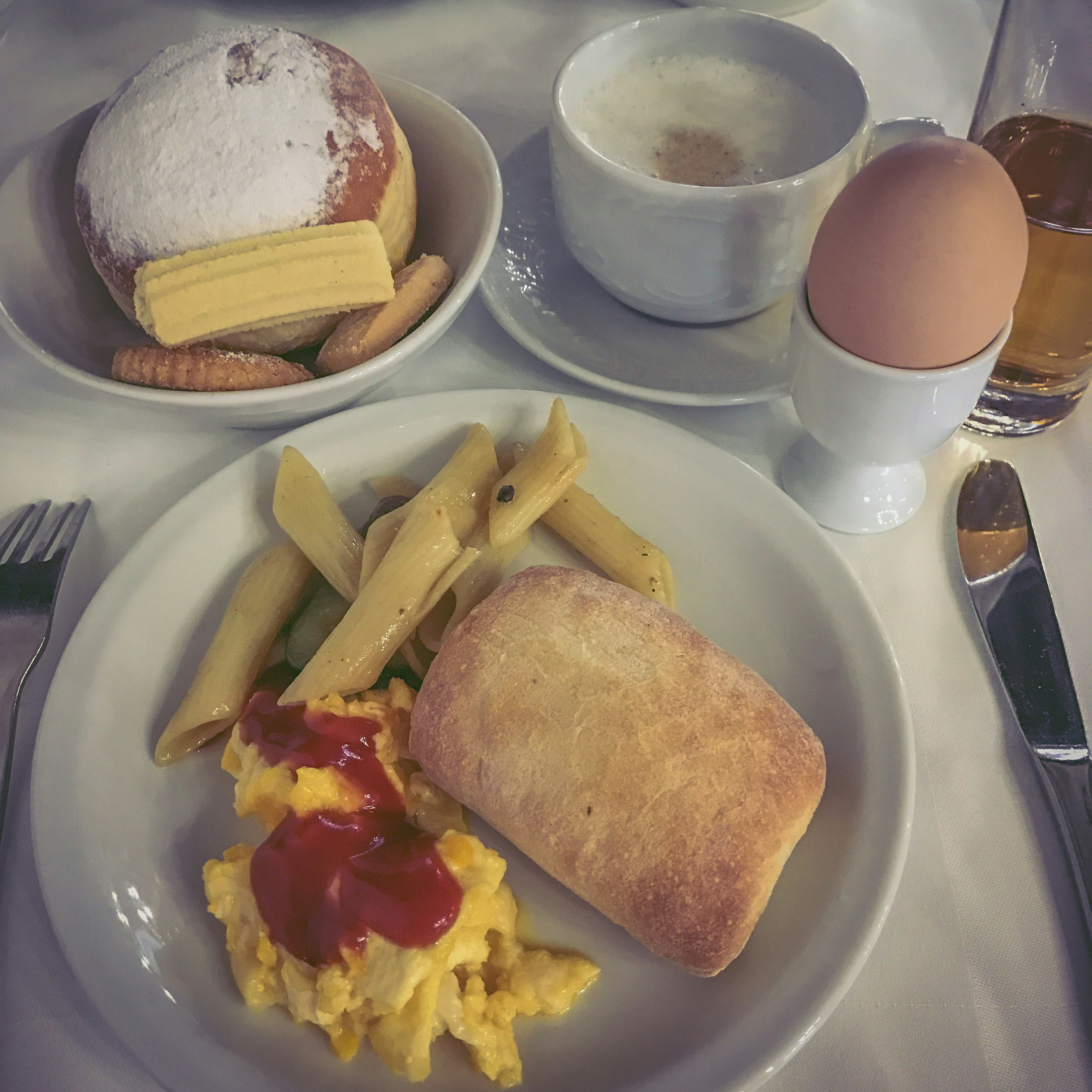 breakfast plate with bread, scrambled eggs, and sausage
