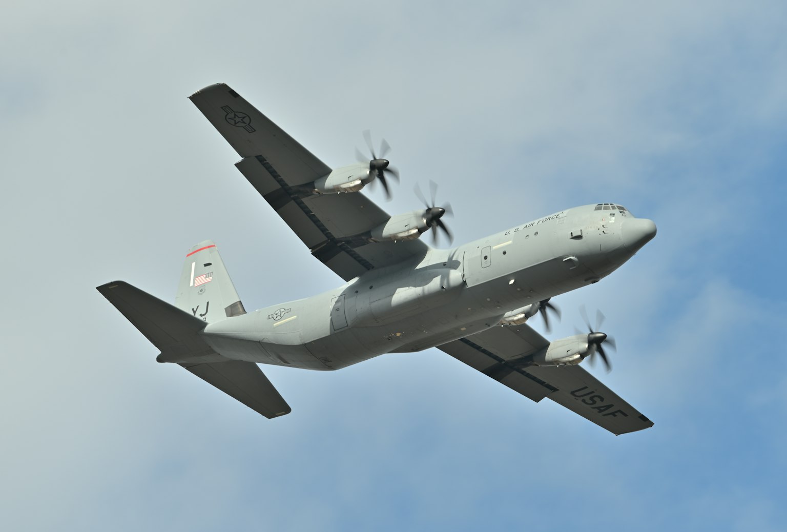 Military aircraft flying against a blue sky