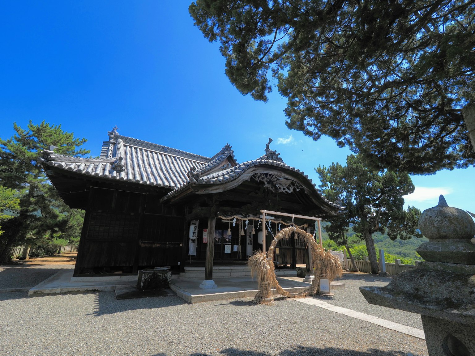 Traditional Japanese shrine building with a blue sky backdrop