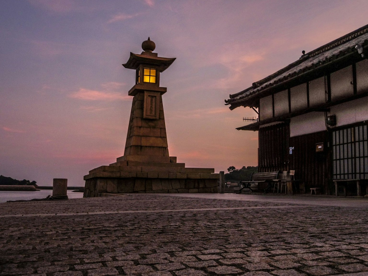 Lantern and traditional building at dusk