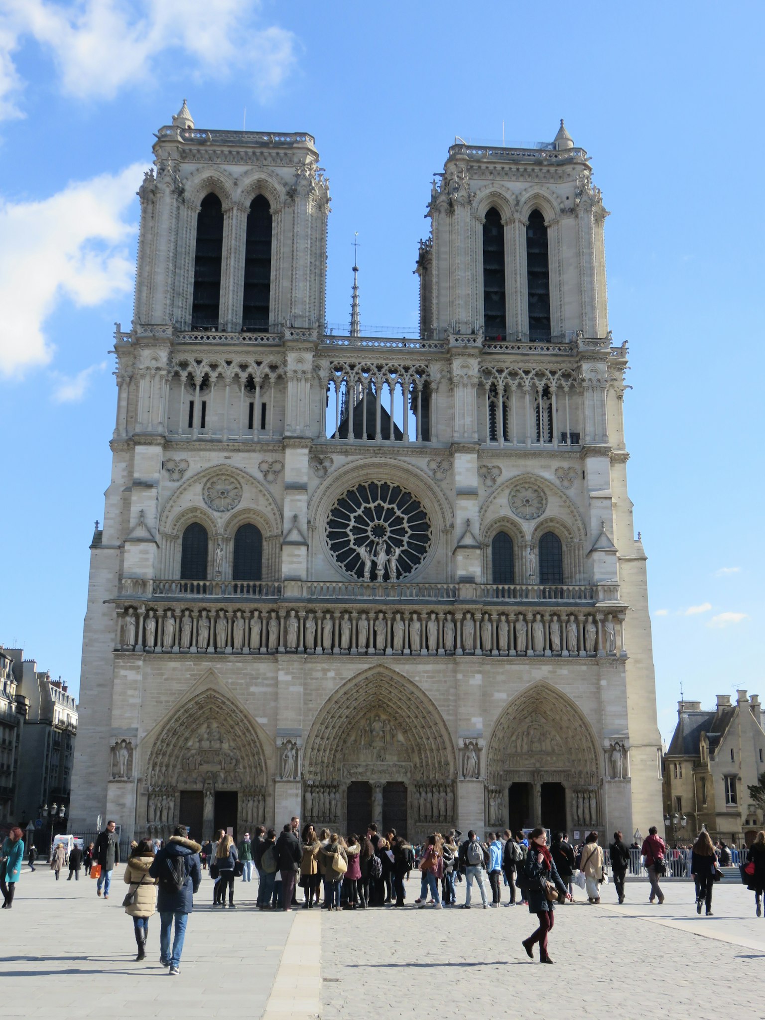 Exterior view of Notre-Dame Cathedral with visitors in the square