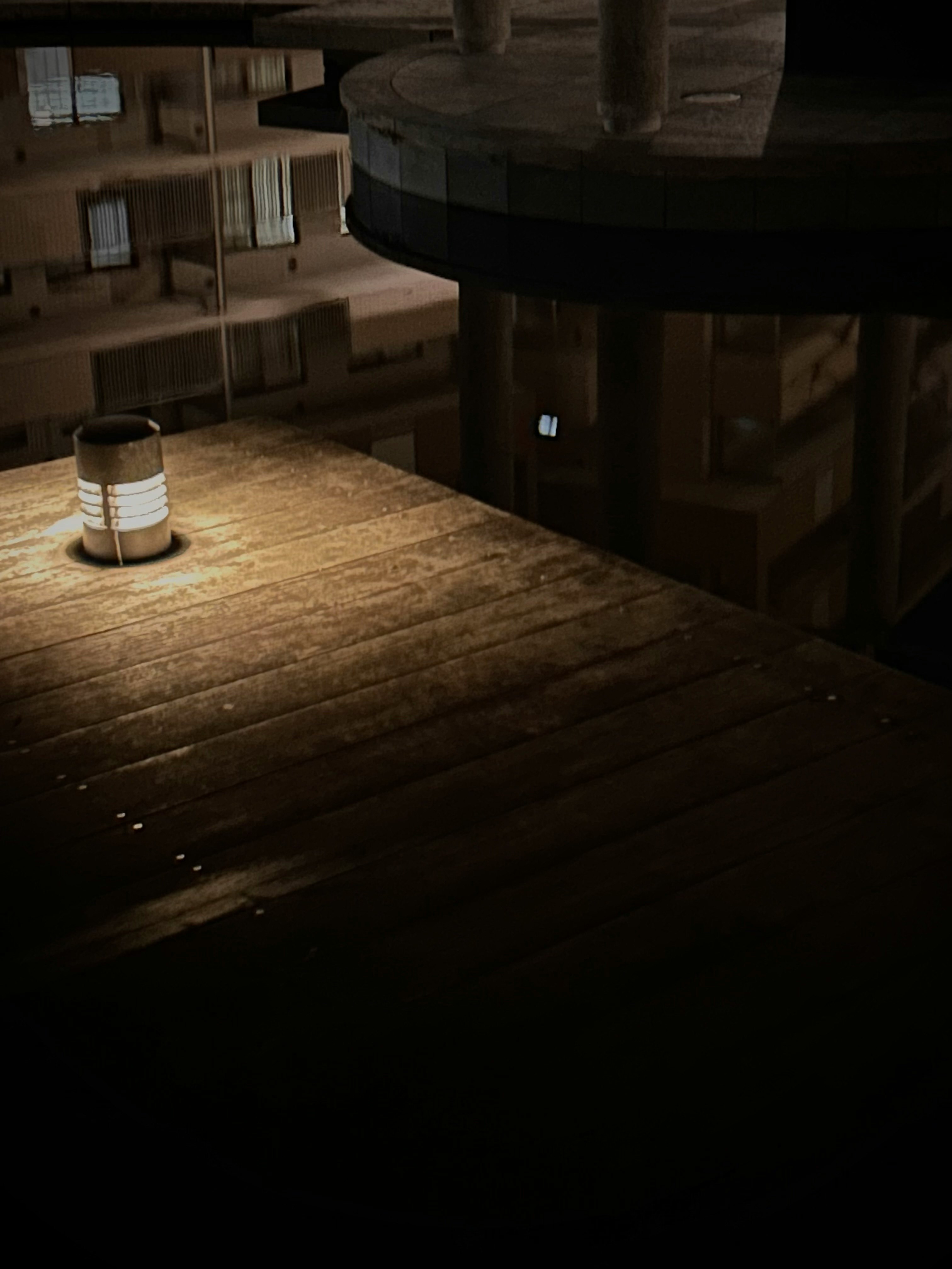 stanza interna scura con scaffali in legno e letto
