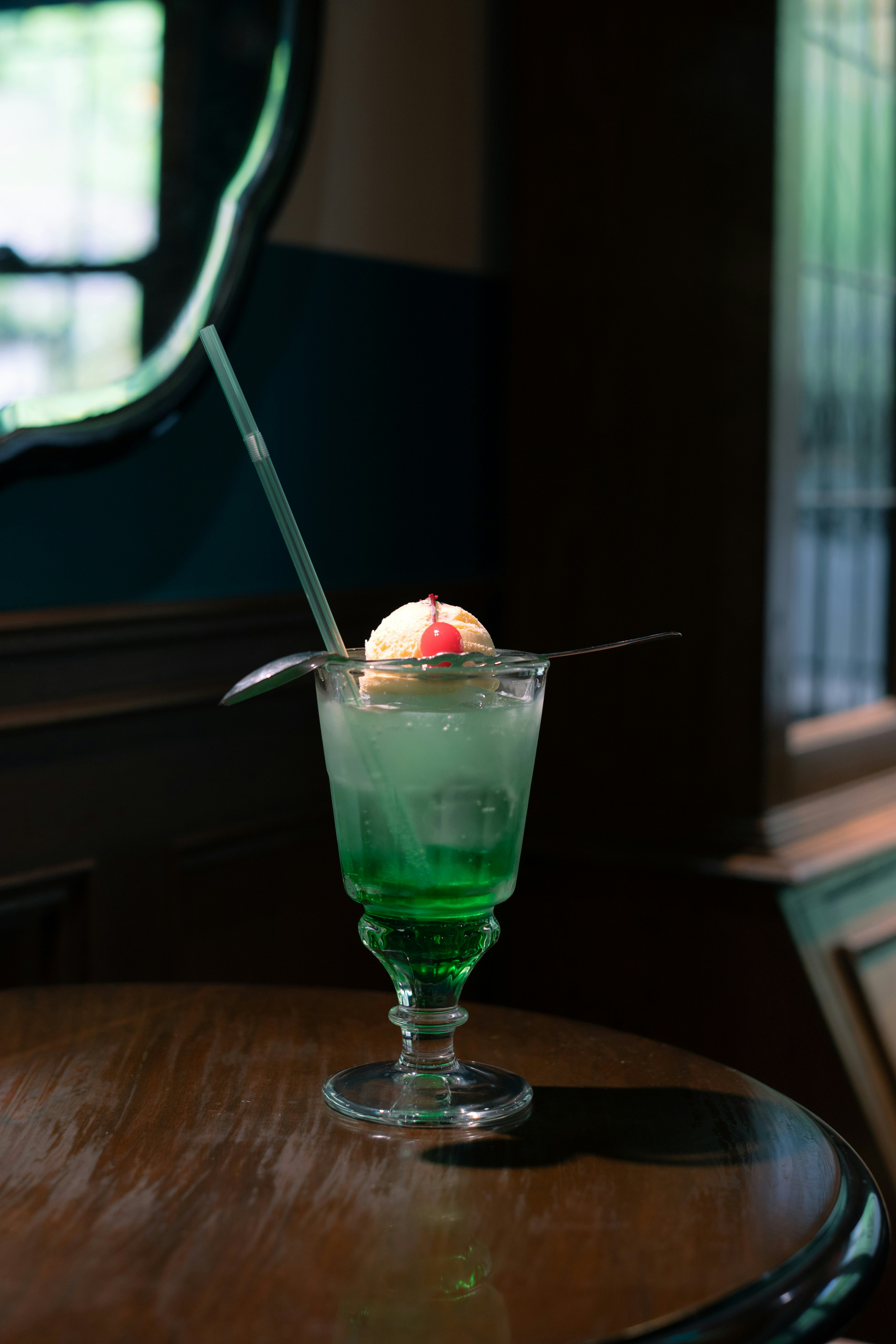 A vibrant cocktail in a glass with a straw