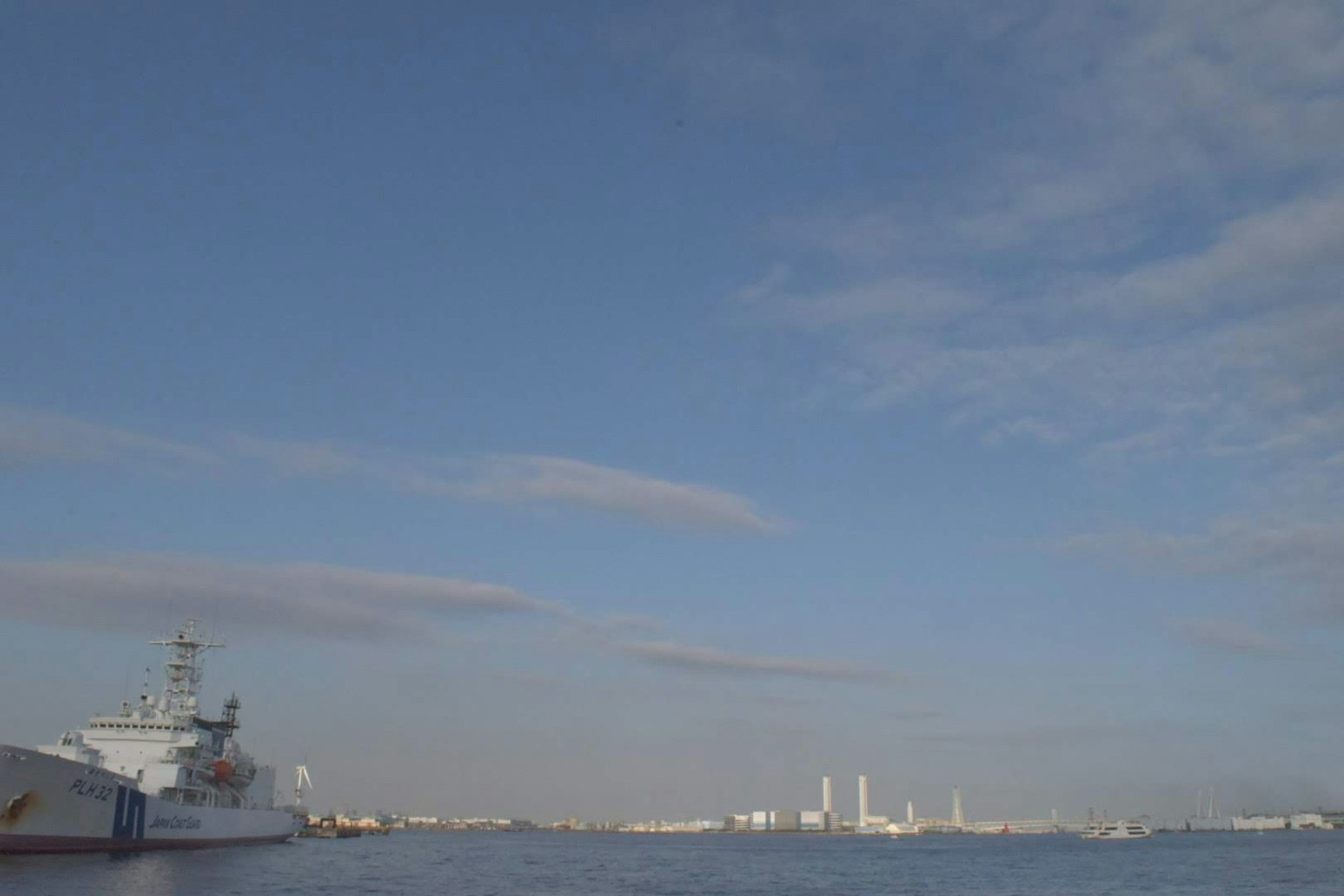 Landscape featuring a blue sky and water with a ship