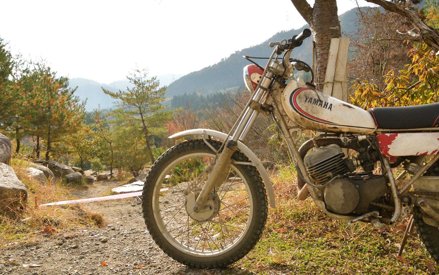 Side view of an off-road motorcycle in a mountainous landscape