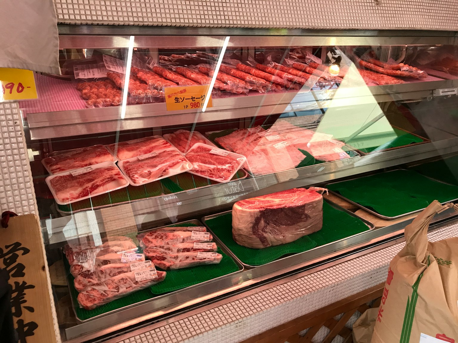 Display case of a butcher shop featuring fresh meat and packaged products