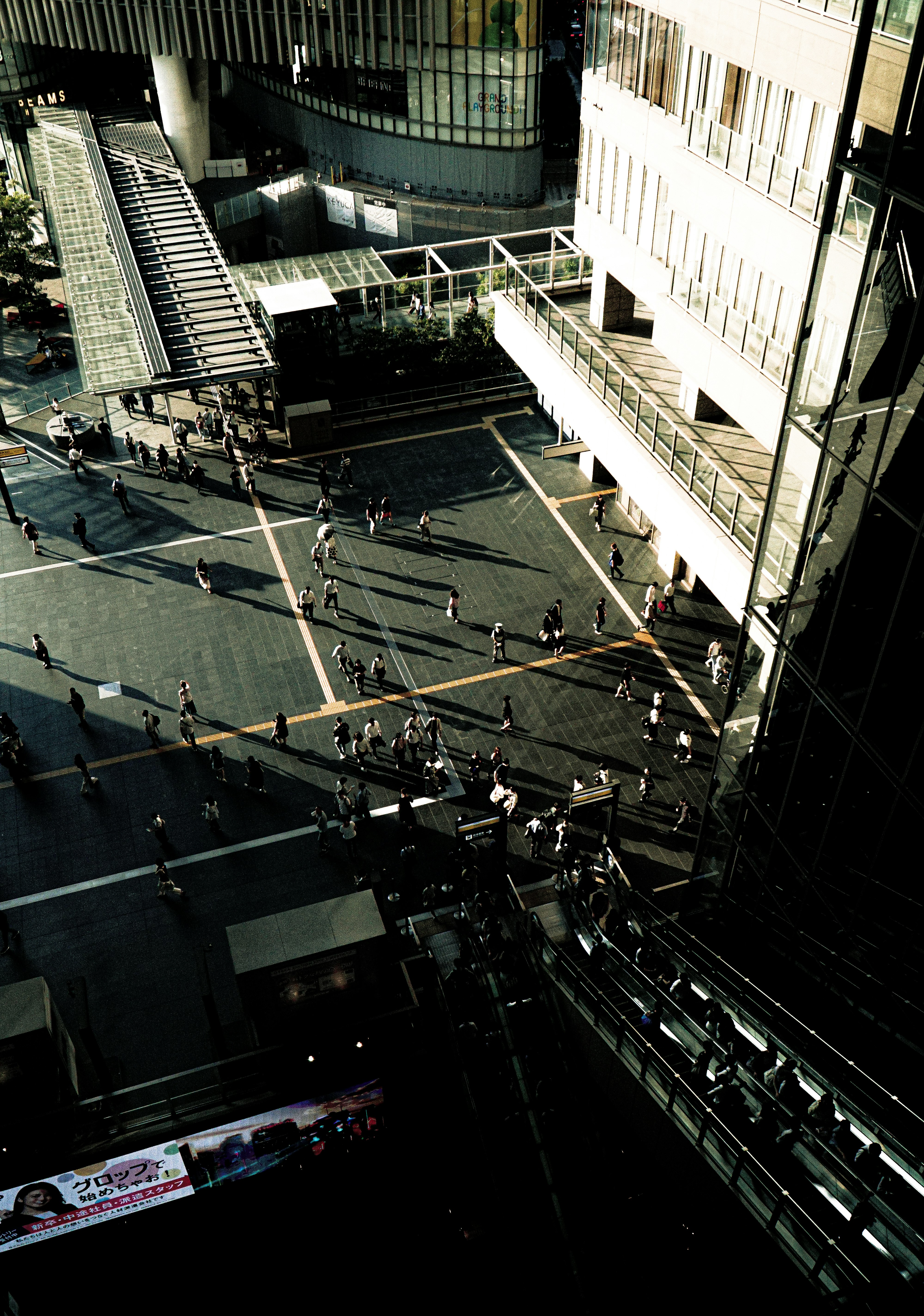 university campus courtyard with surrounding buildings and people walking