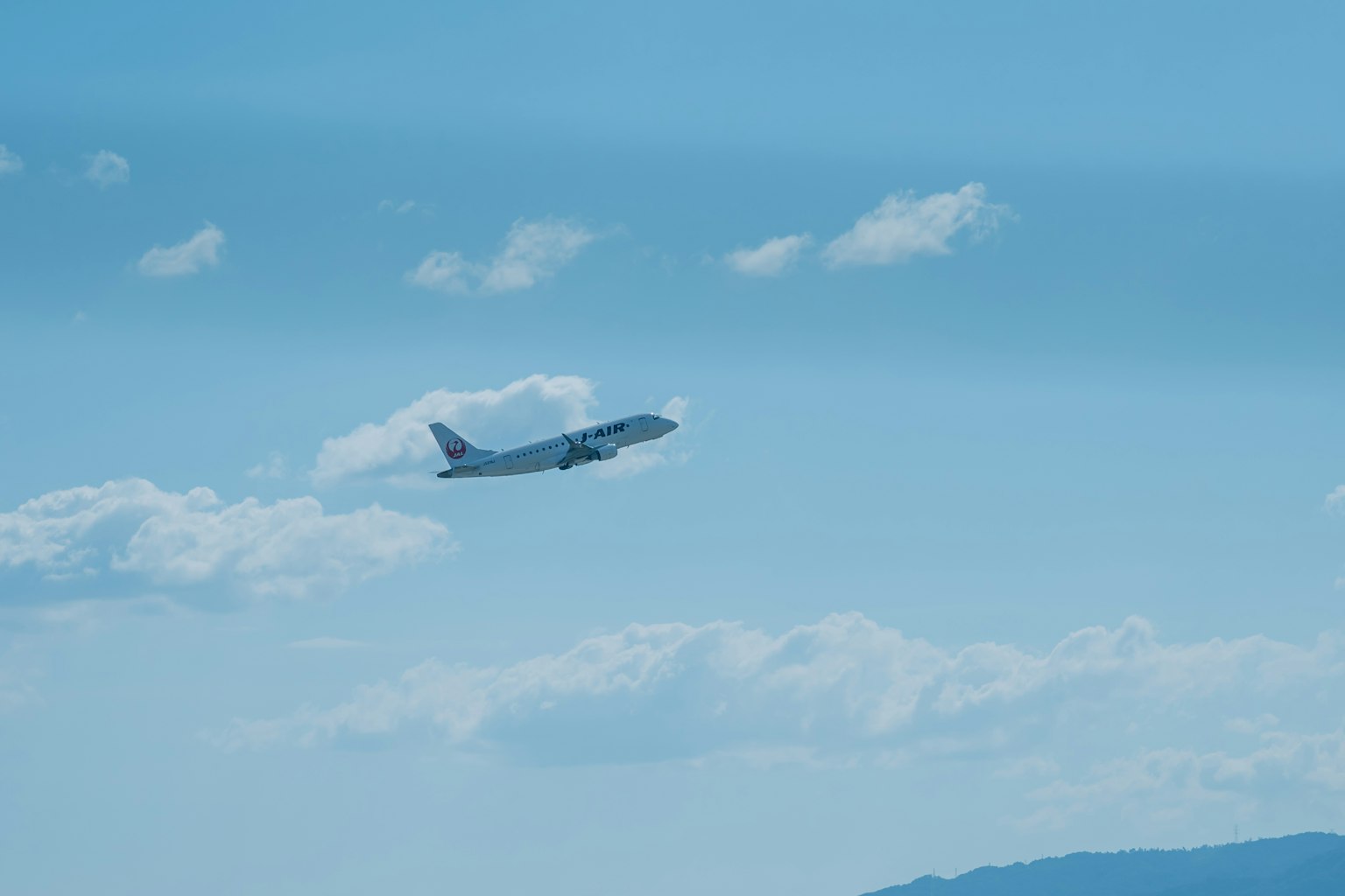 푸른 하늘에서 이륙하는 비행기