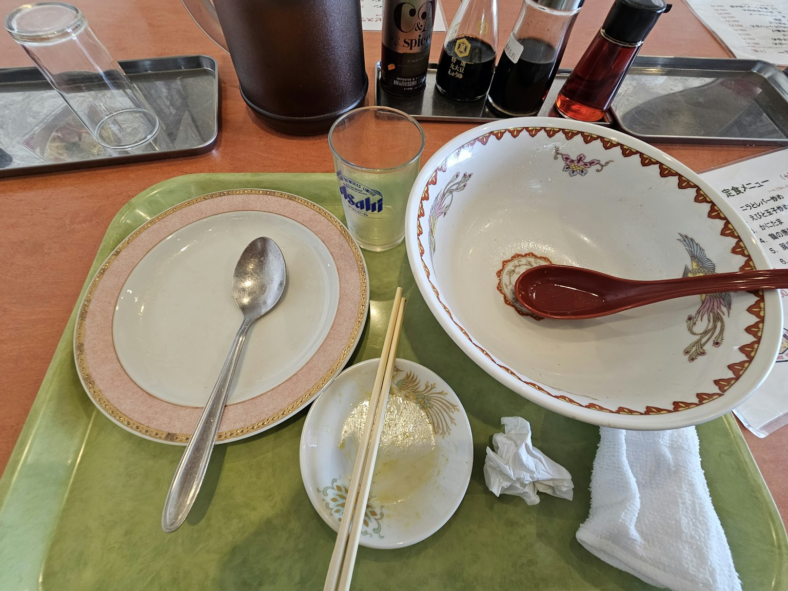 Table setting with used dishes including a bowl and spoon
