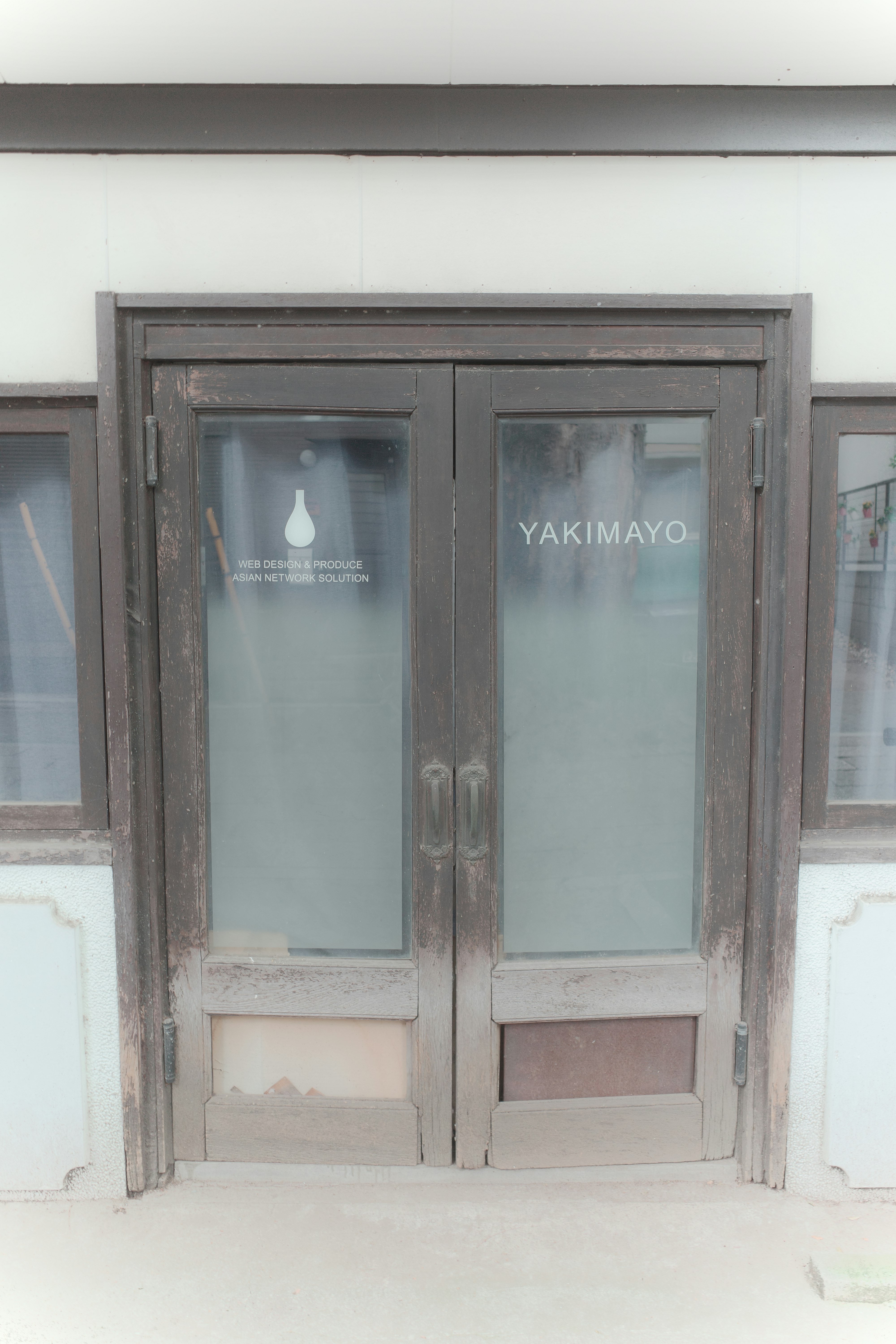 wooden storefront entrance with glass doors