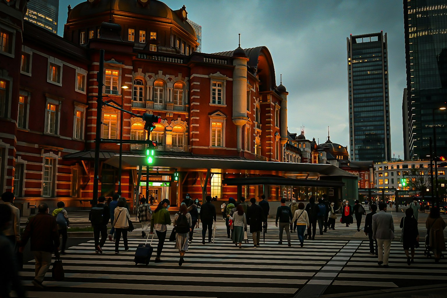 Night view of Tokyo Station with pedestrians crossing