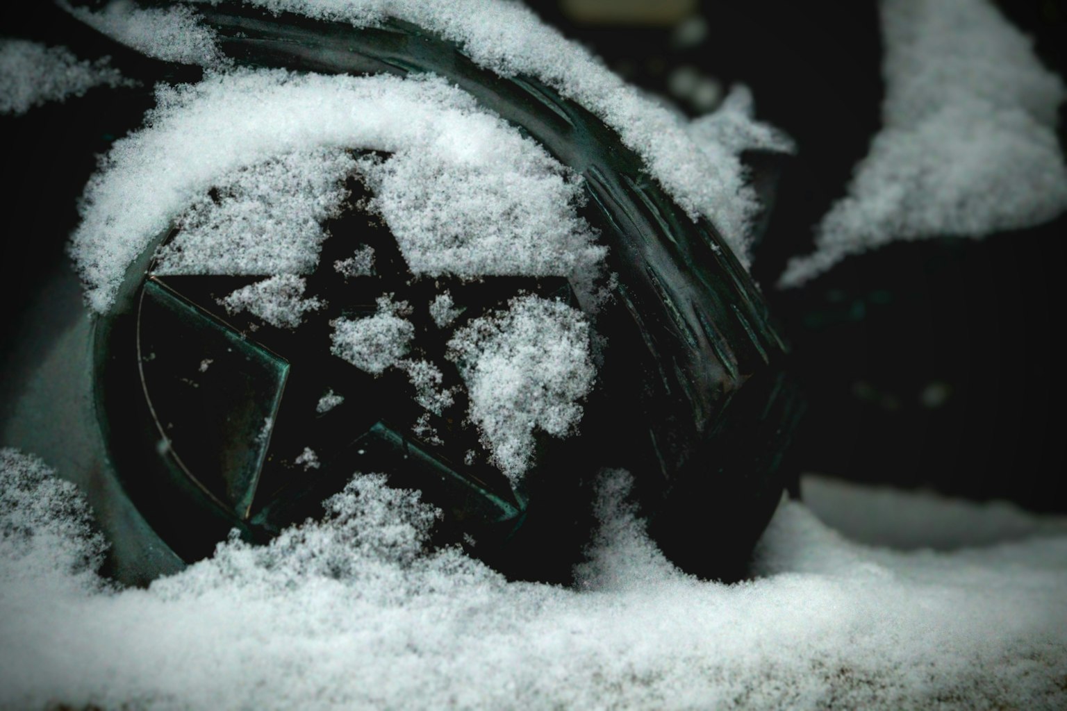 被雪覆盖的黑色轮子的特写