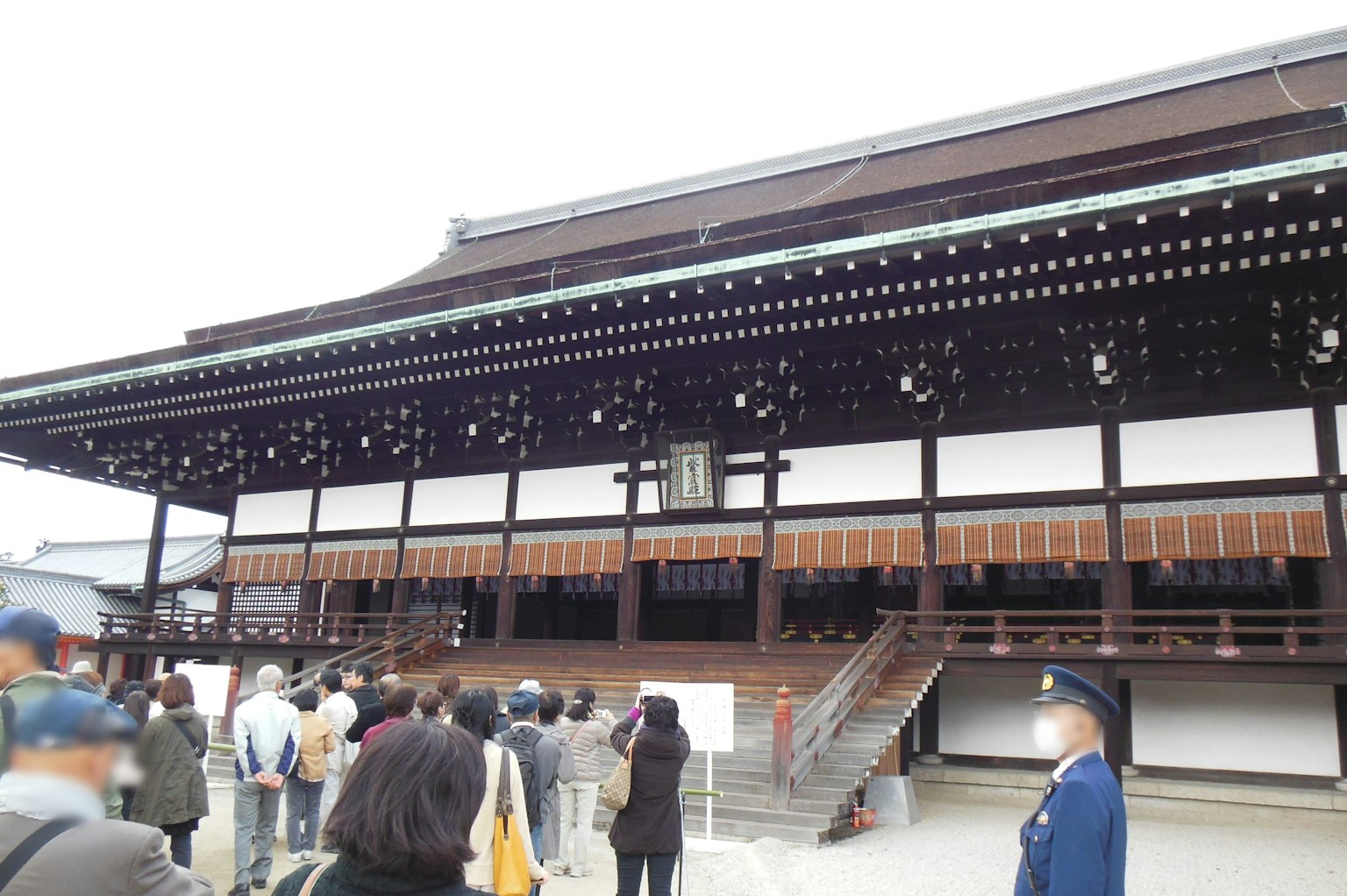 Traditional Japanese architecture exterior with a line of visitors