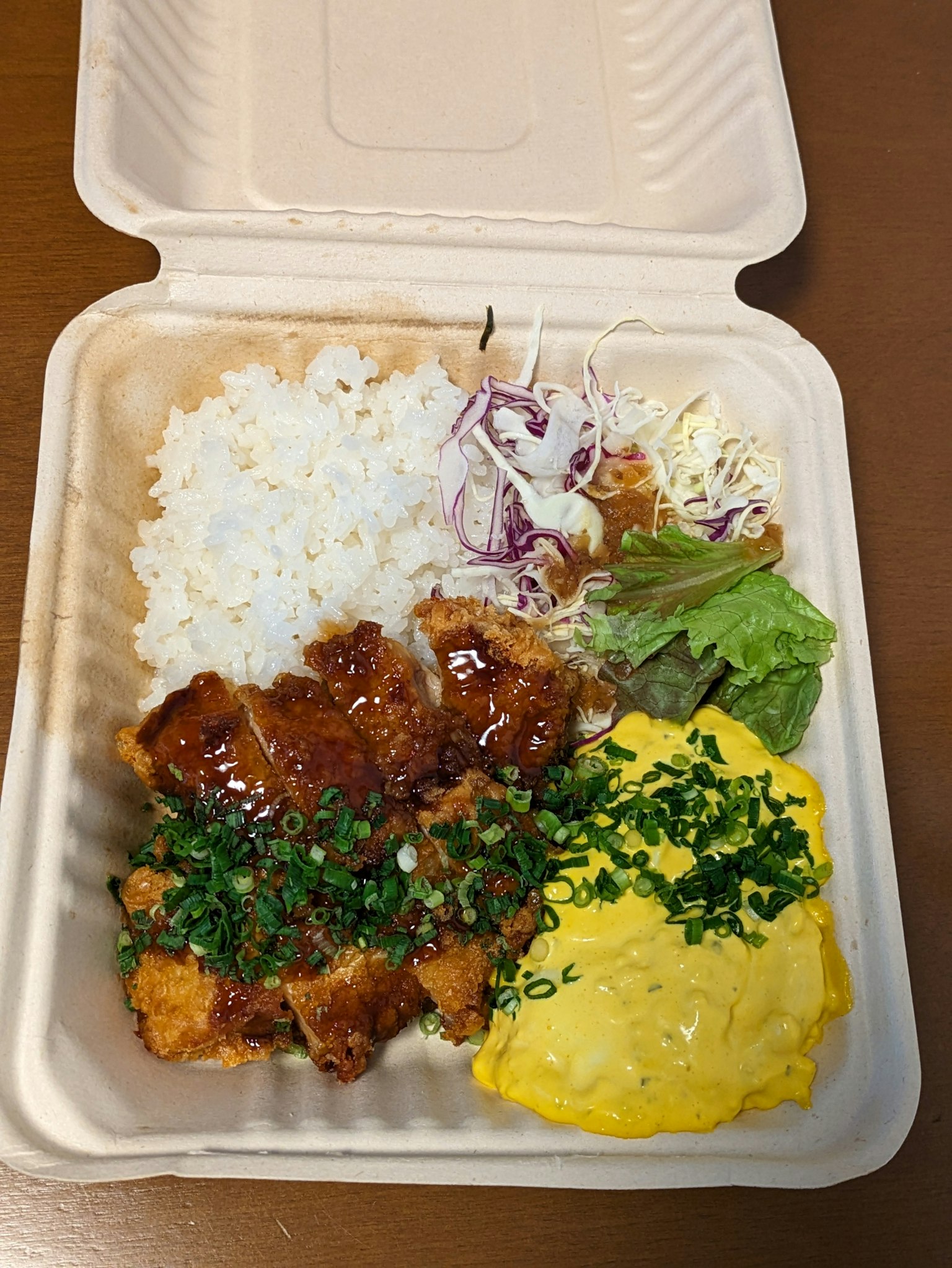 便当盒内有白米饭、照烧鸡肉、炒蛋和沙拉