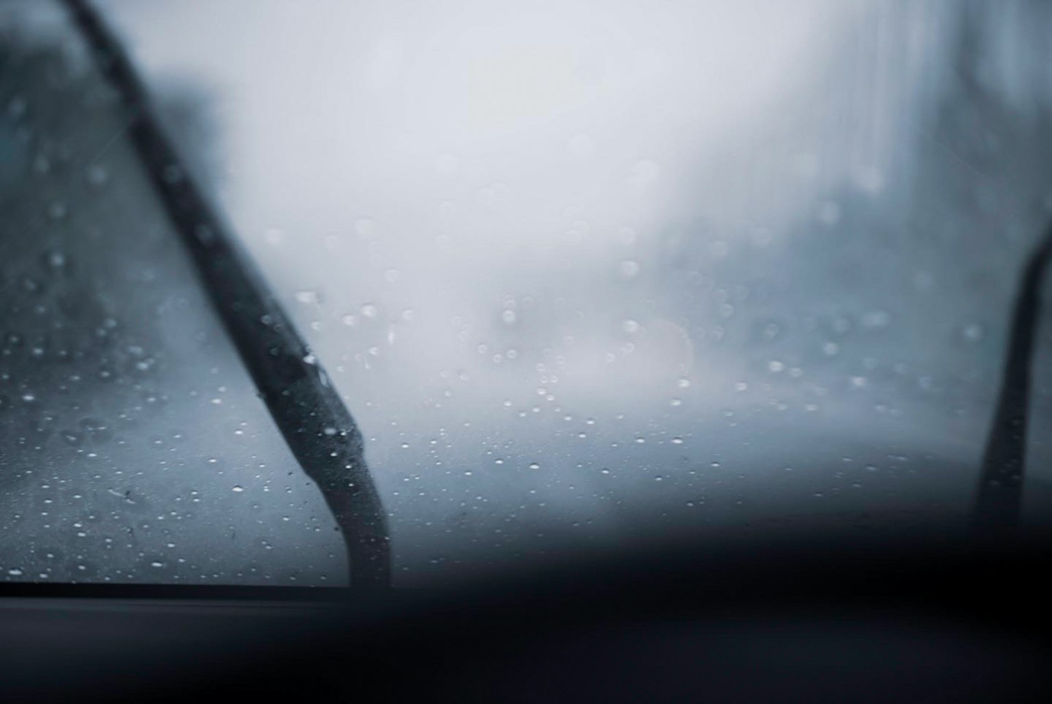 Close-up shot of a car windshield during rain blurred visibility