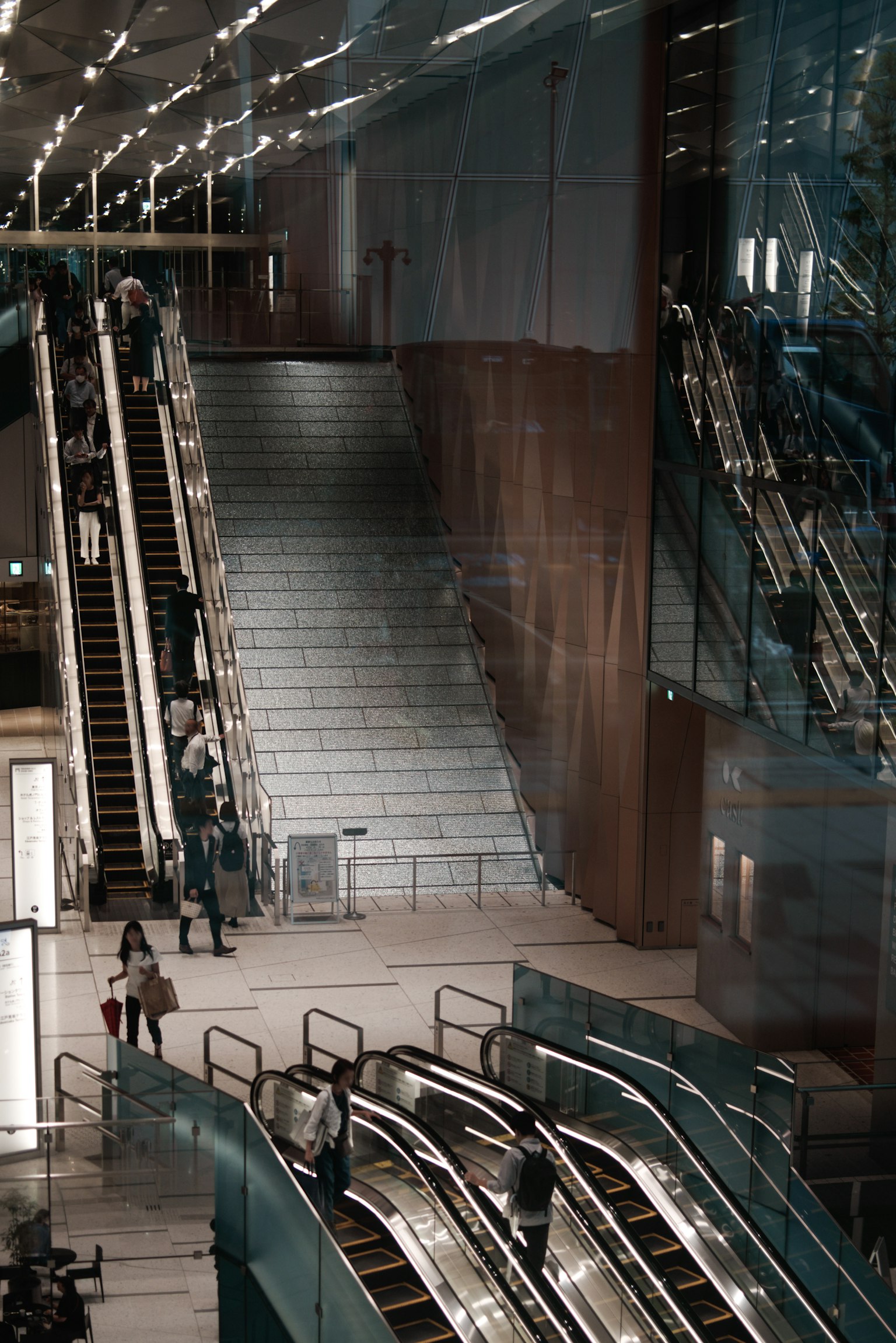 Interior view of a modern building featuring escalators and stairs