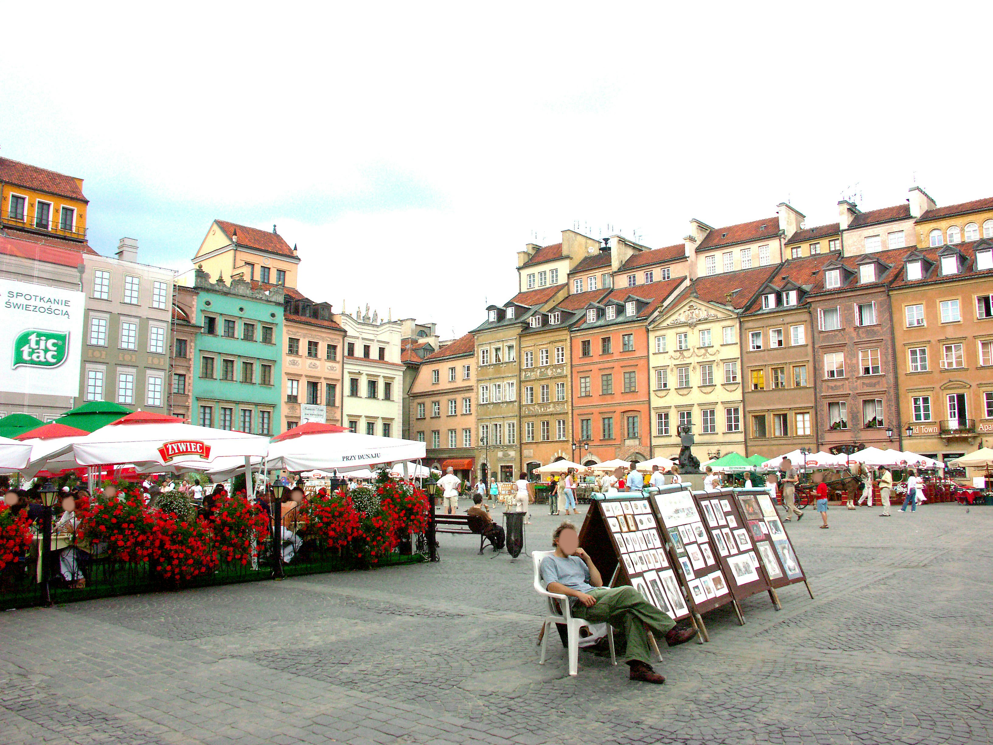 outdoor market square with flower beds and stalls