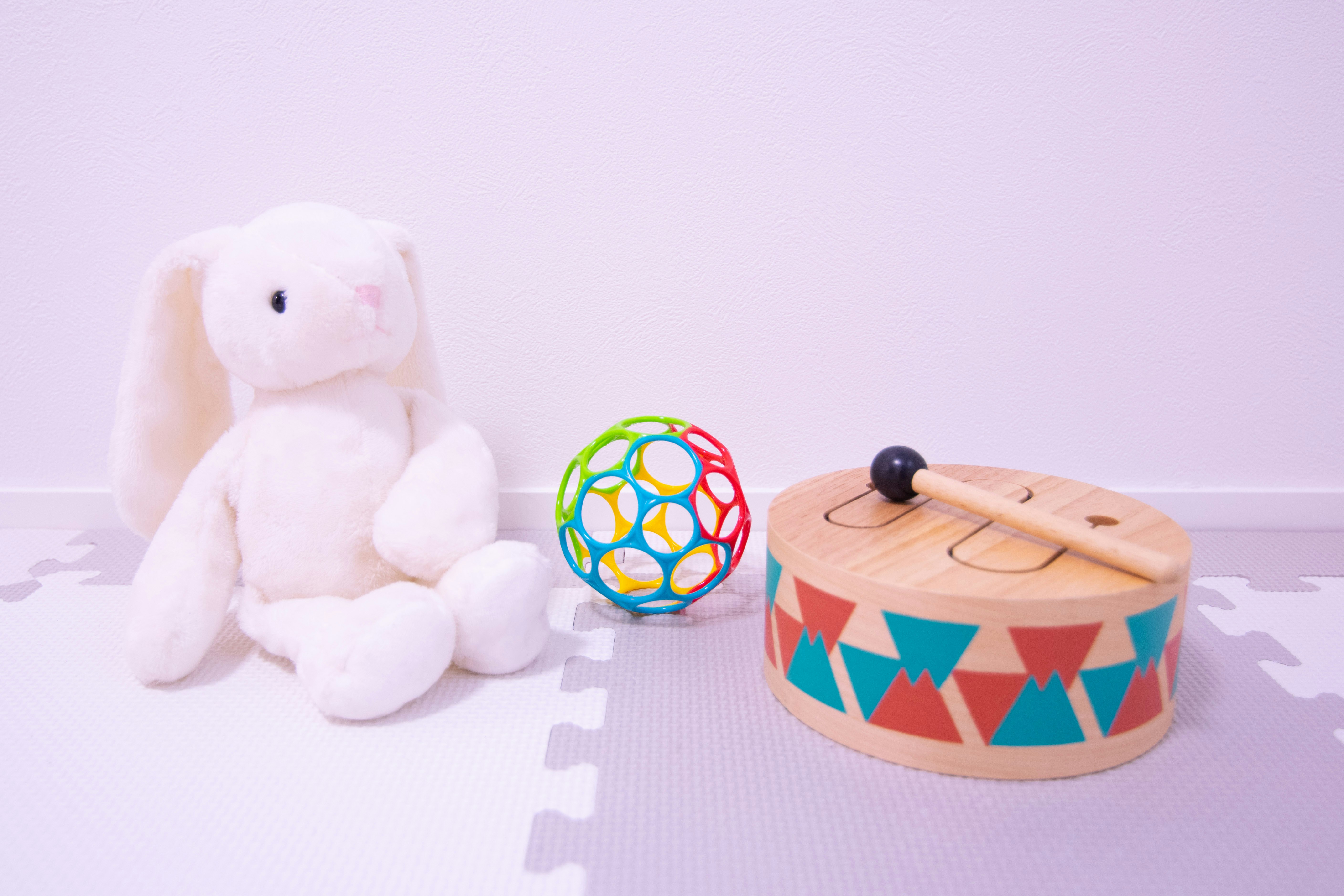 plush bunny and wooden baby toys on a white background