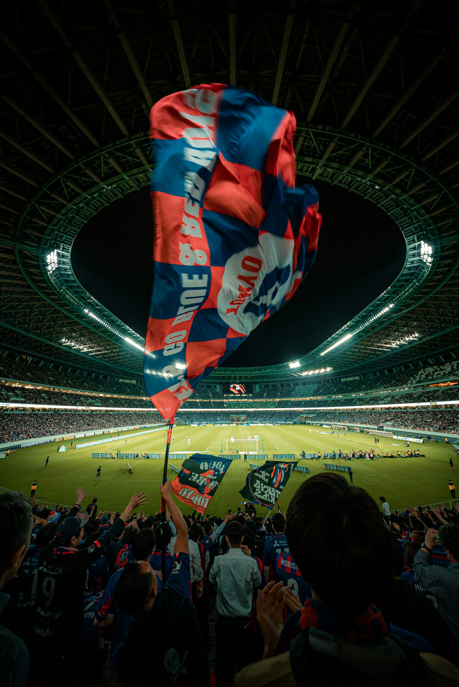 Crowd waving flags in a soccer stadium