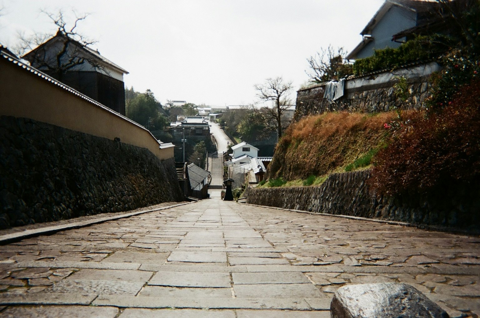 Stone-paved slope with a person walking down