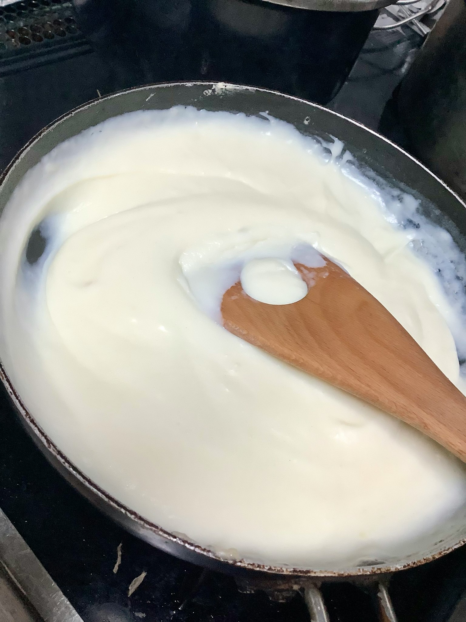 Creamy sauce being stirred in a pan