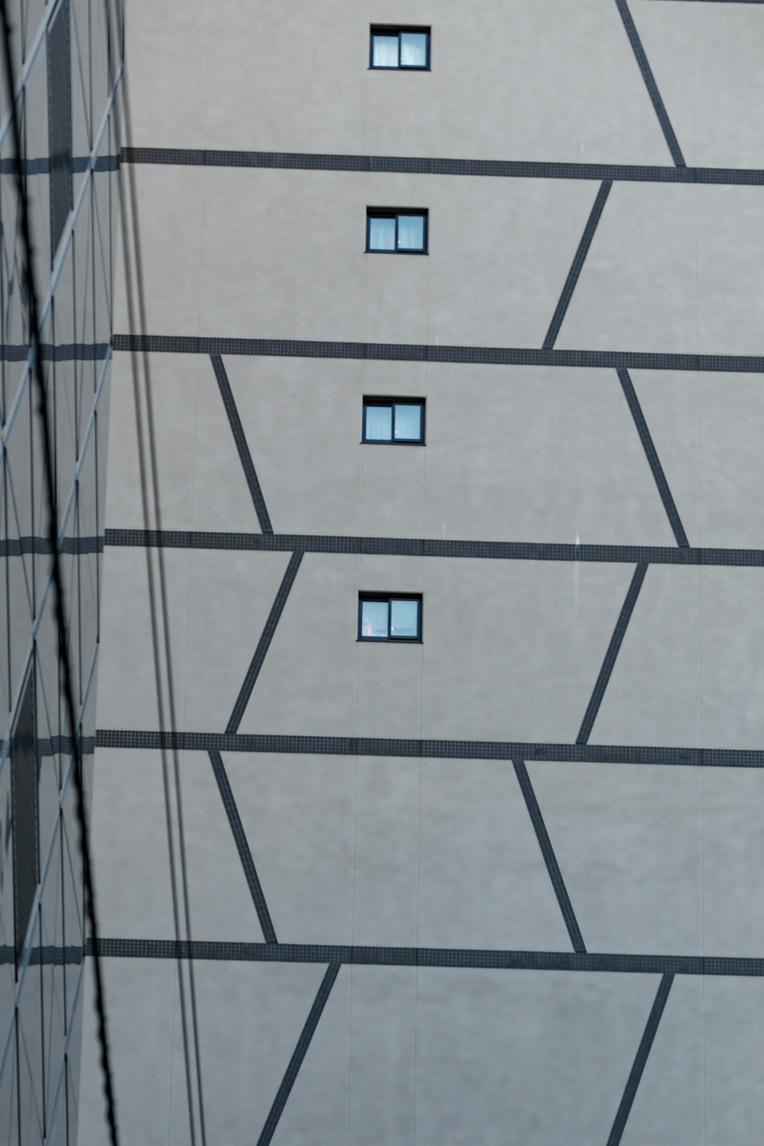 Diagonal lines and window arrangement on a building facade